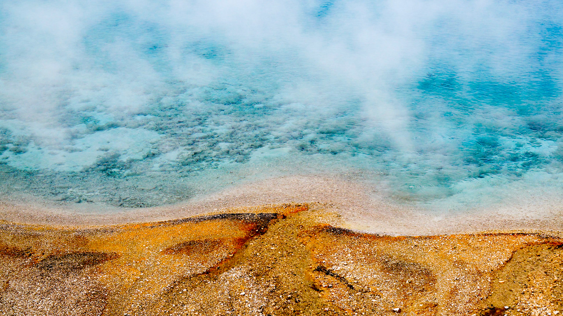On a rany day in summer, the Prismatic Springs in Yellowstone Park steam up quite a lot.