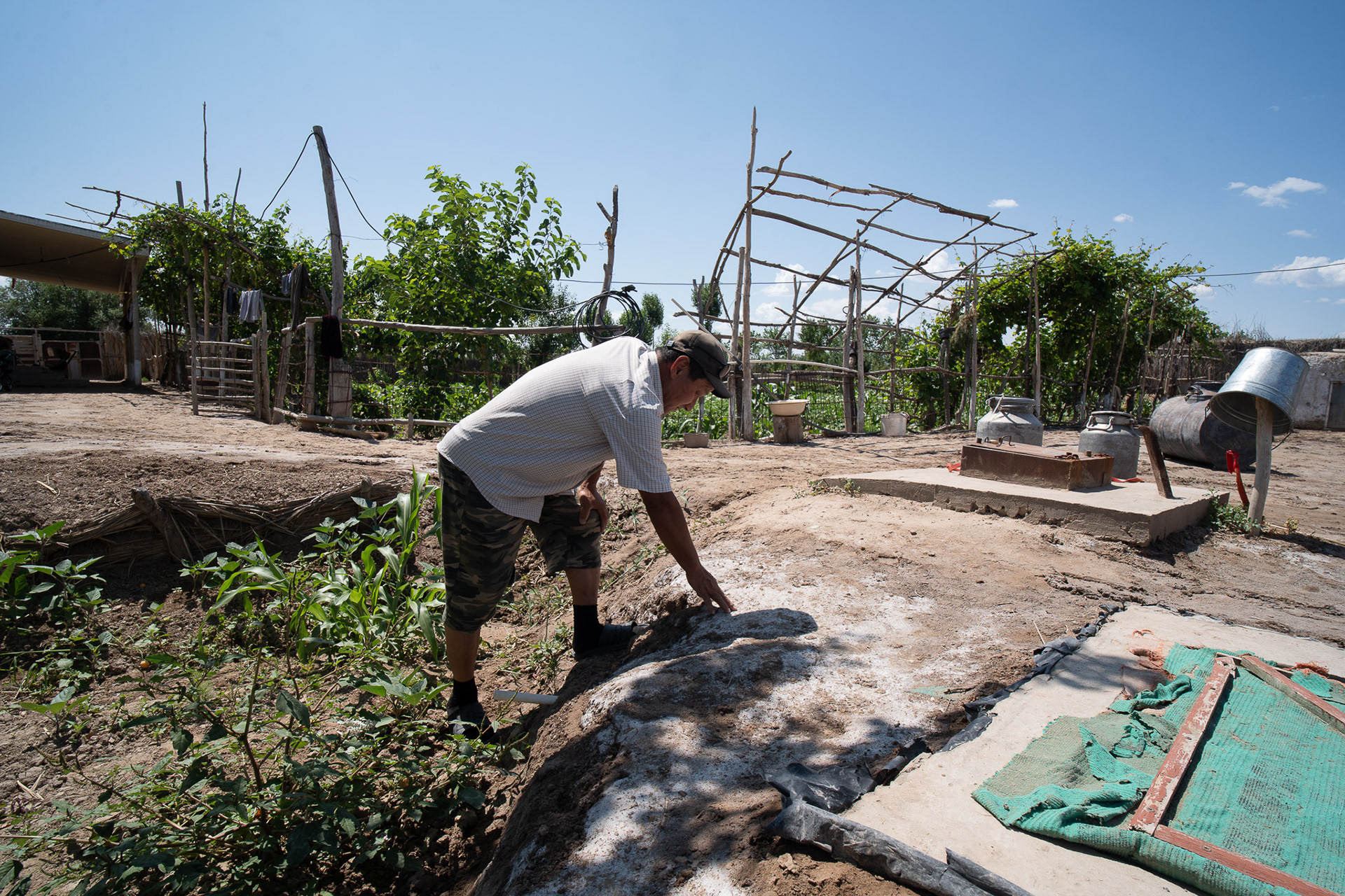 Un agriculteur montre du doigt les traces laissées par le sel, qui s'infiltre dans les sols depuis que le lit de la mer s'est asséché