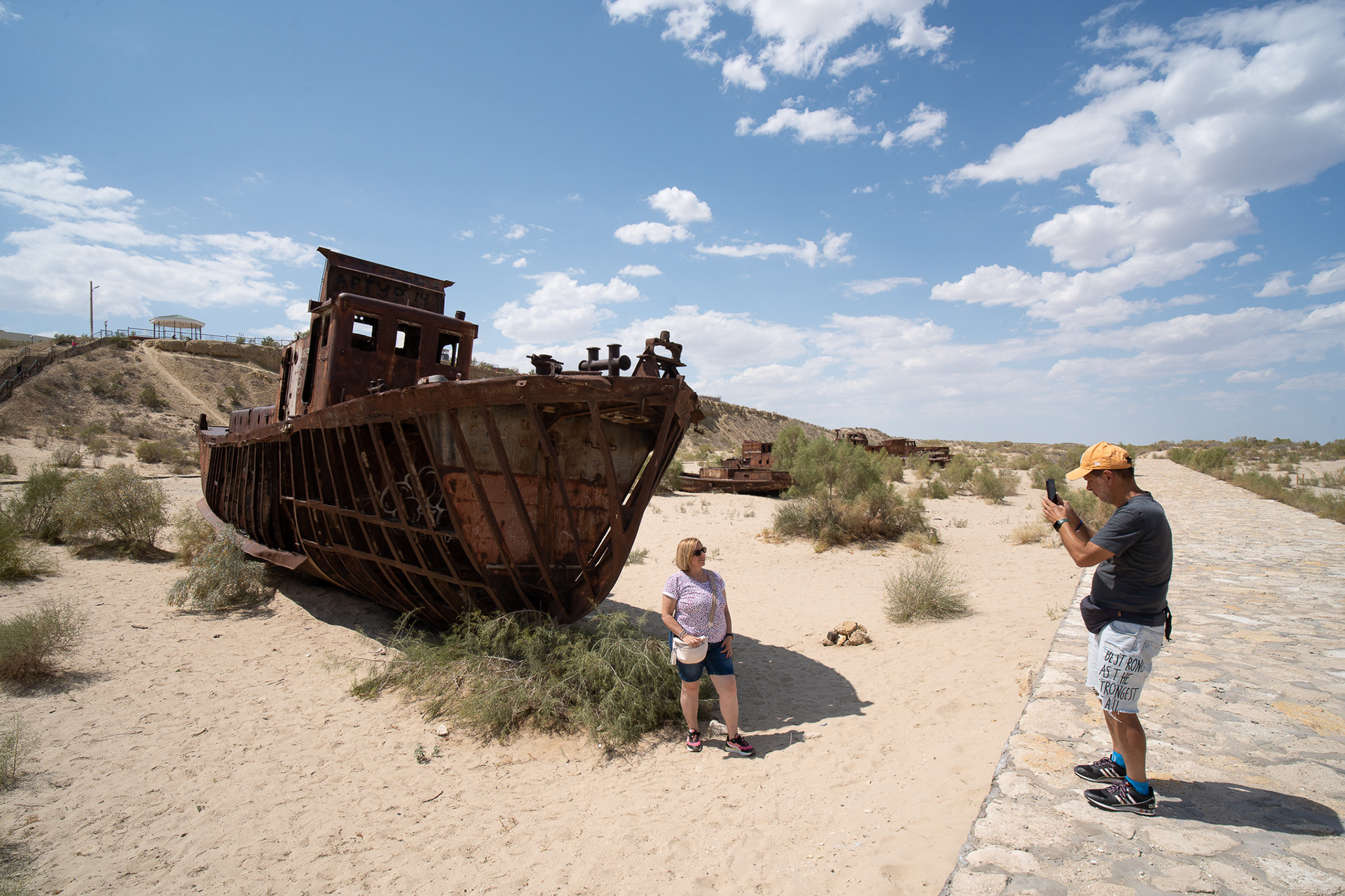 Une touriste italienne pose devant la carcasse d'un navire échoué