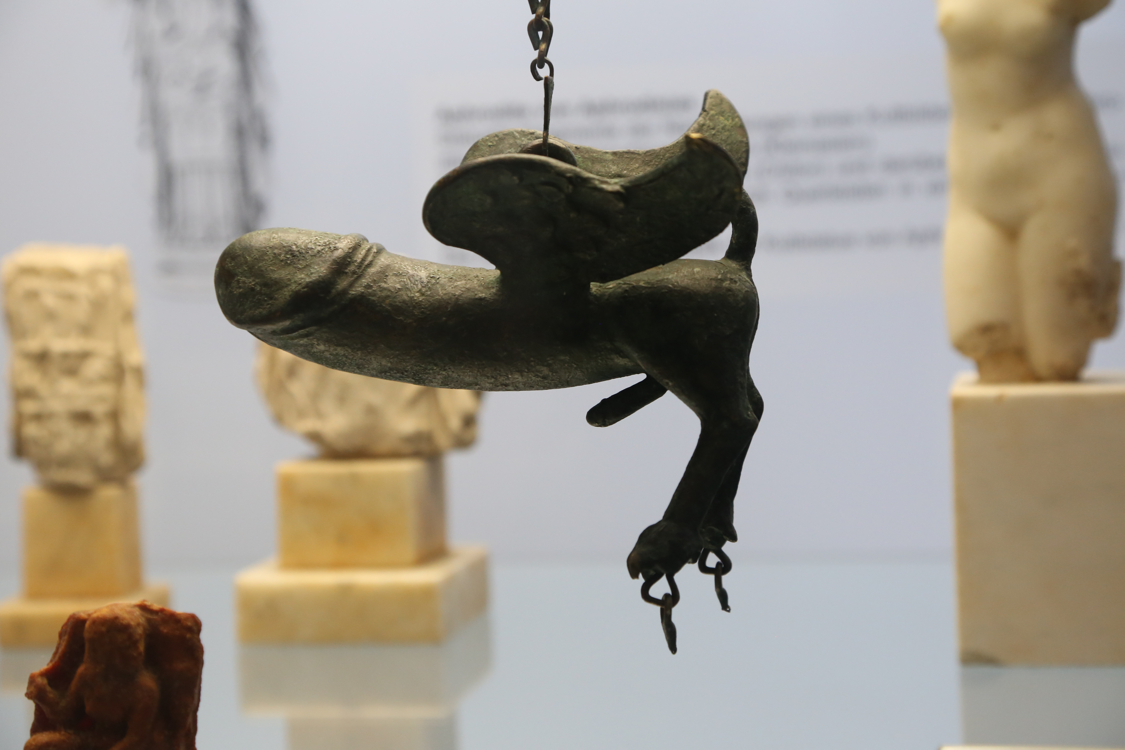 Fascinum — Roman winged phallus amulet with bell attachments, Museum August Kestner, Hannover