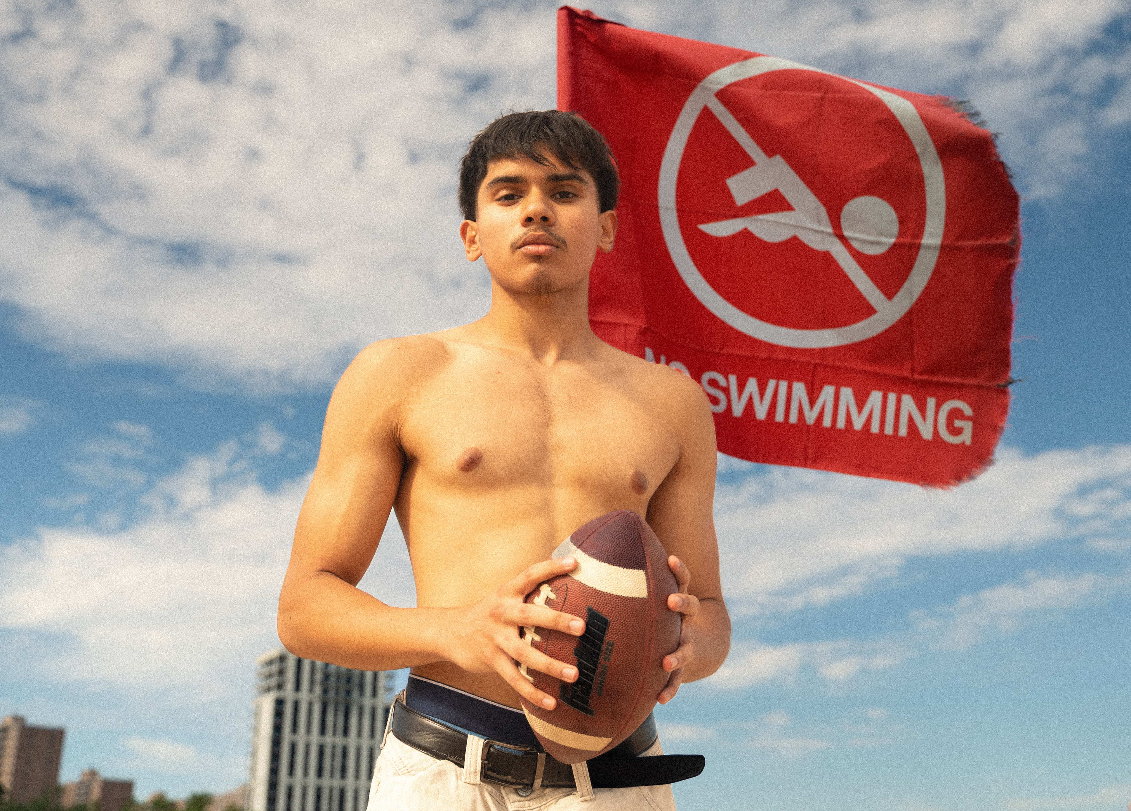 CONEY ISLAND, NEW YORK - JULY 19, 2025: Mohammed photographs an American football scene on the beach at Coney Island, Brooklyn, inspired by Top Gun: Maverick.
