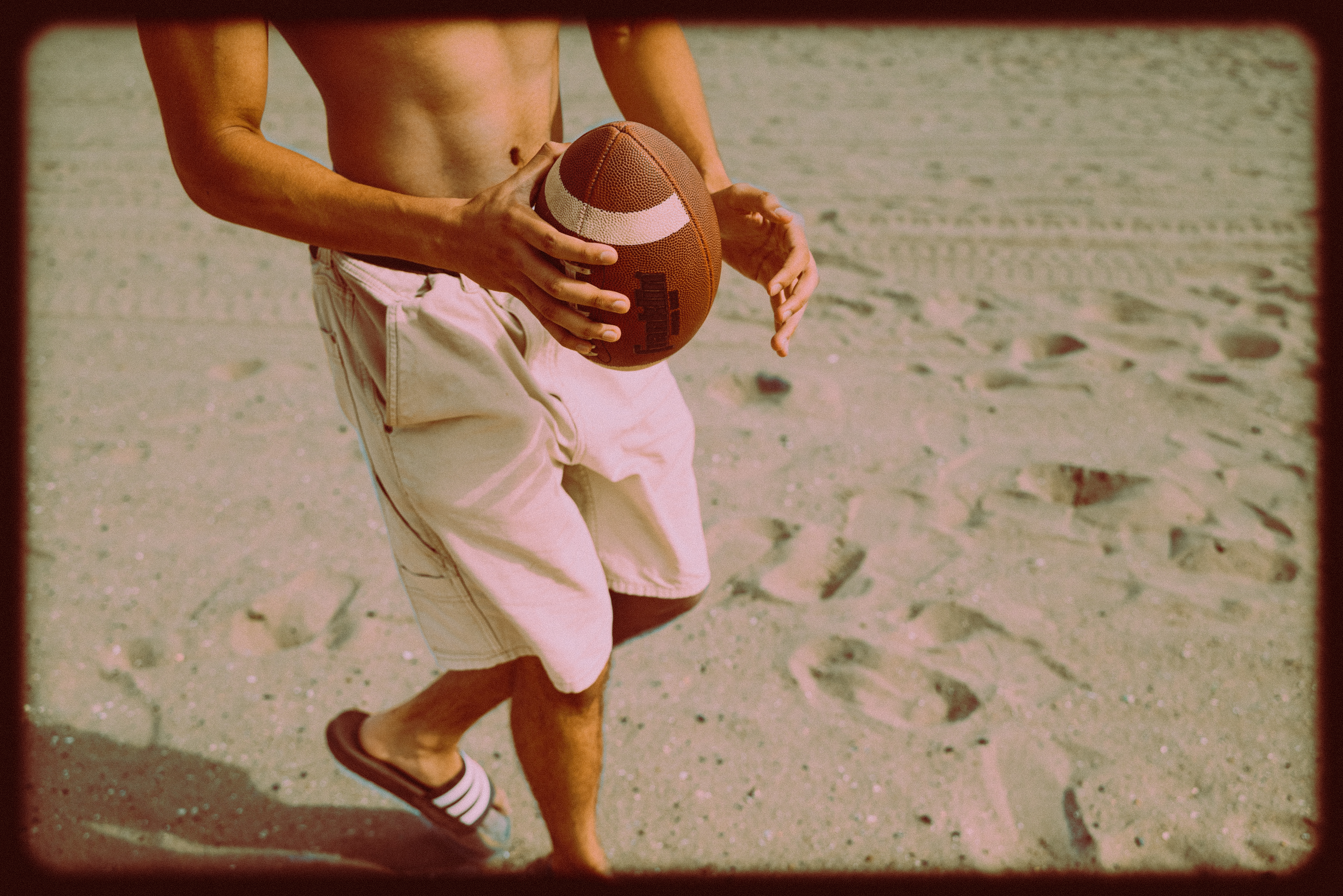 CONEY ISLAND, NEW YORK - JULY 19, 2025: Mohammed photographs an American football scene on the beach at Coney Island, Brooklyn, inspired by Top Gun: Maverick.