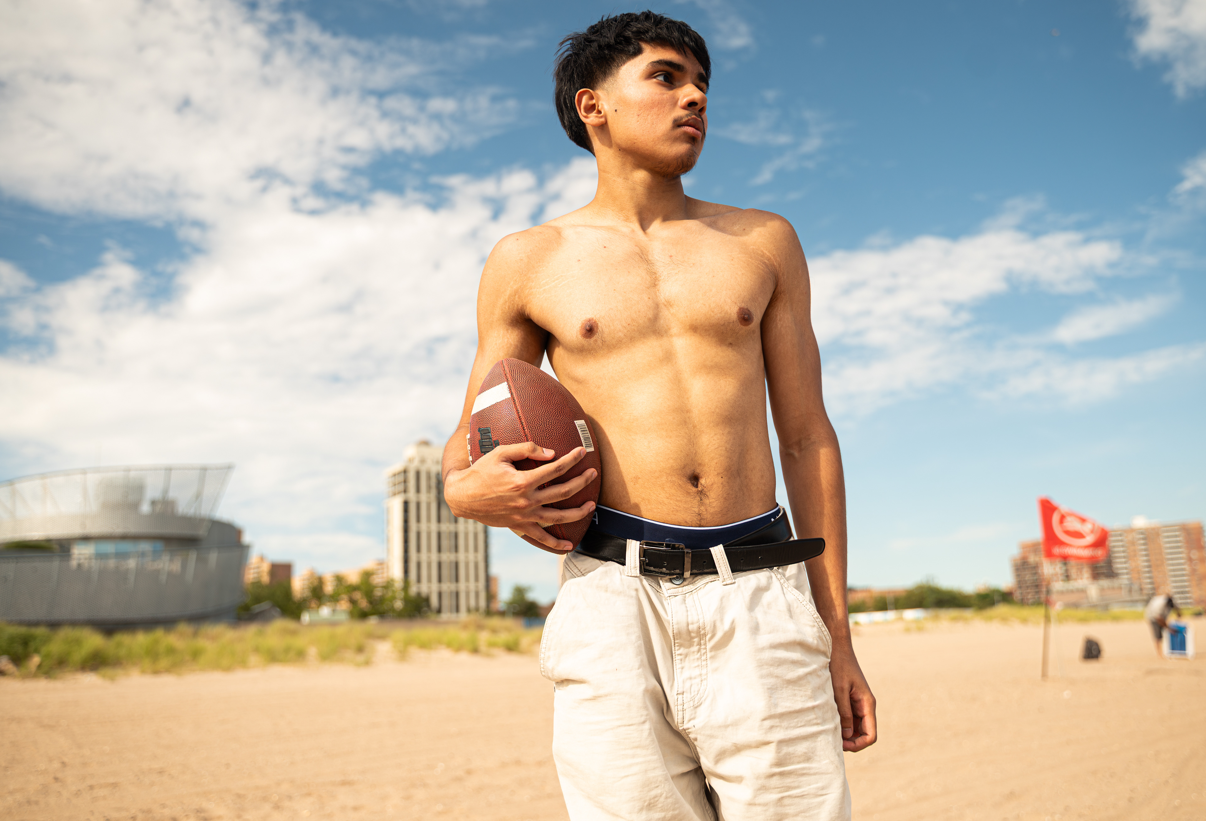 CONEY ISLAND, NEW YORK - JULY 19, 2025: Mohammed photographs an American football scene on the beach at Coney Island, Brooklyn, inspired by Top Gun: Maverick.