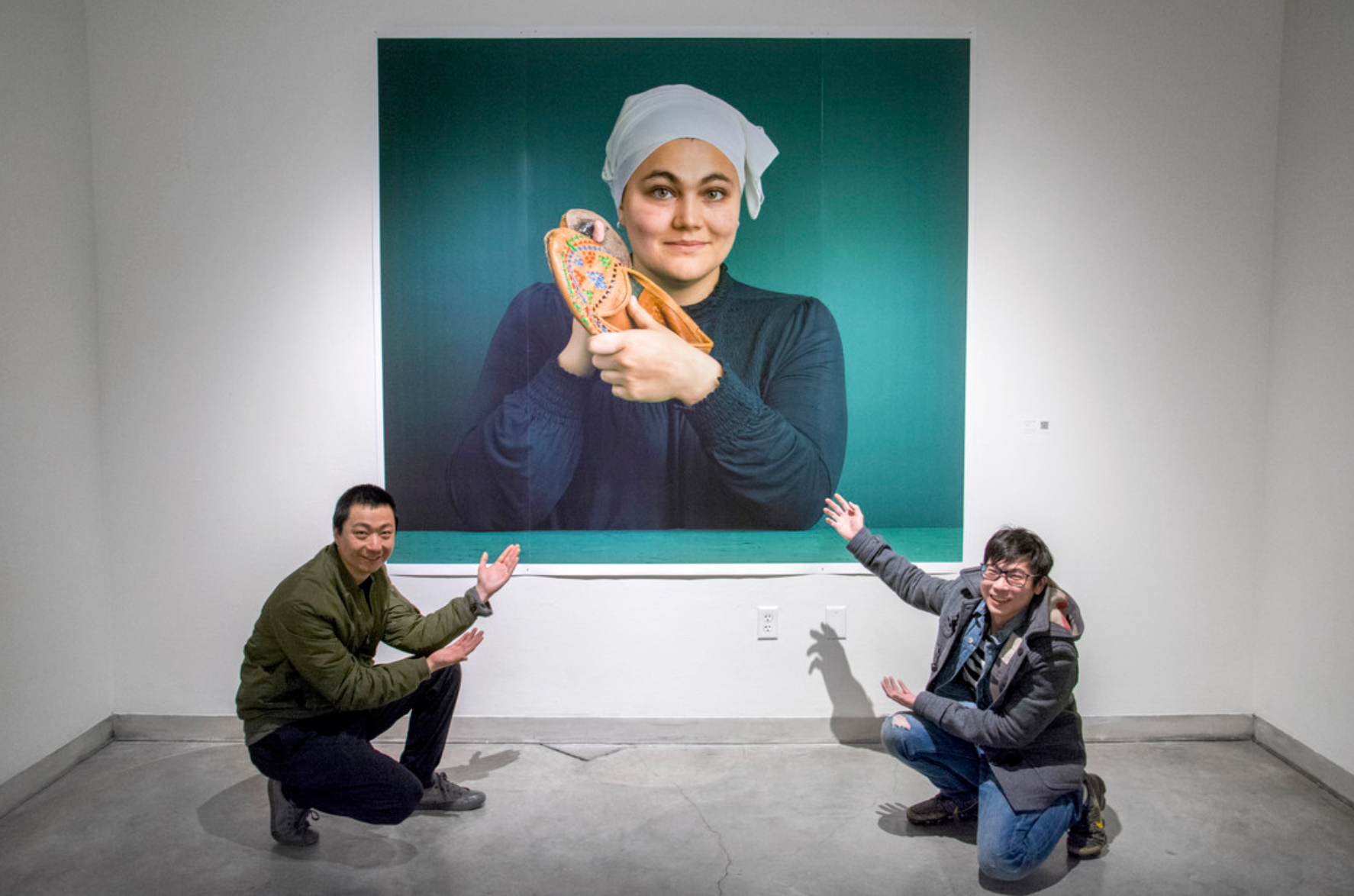 Artists Shun Jie Yong and Peng Wu with their work
