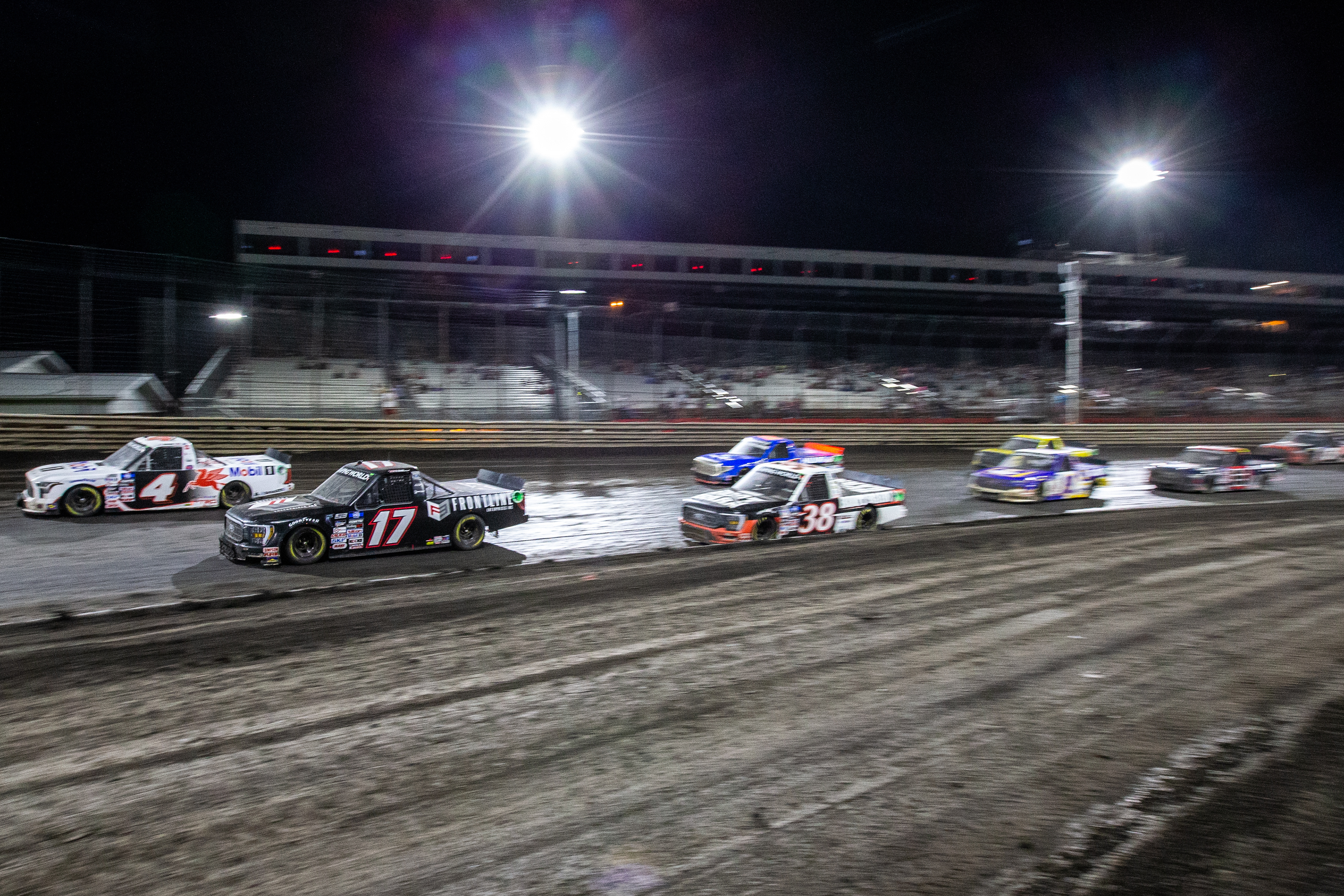 The field passes down the frontstretch during the Clean Harbors 150 NASCAR Camping World Truck Series Race at Knoxville Raceway in Knoxville, Iowa on Saturday, June 18, 2022.
