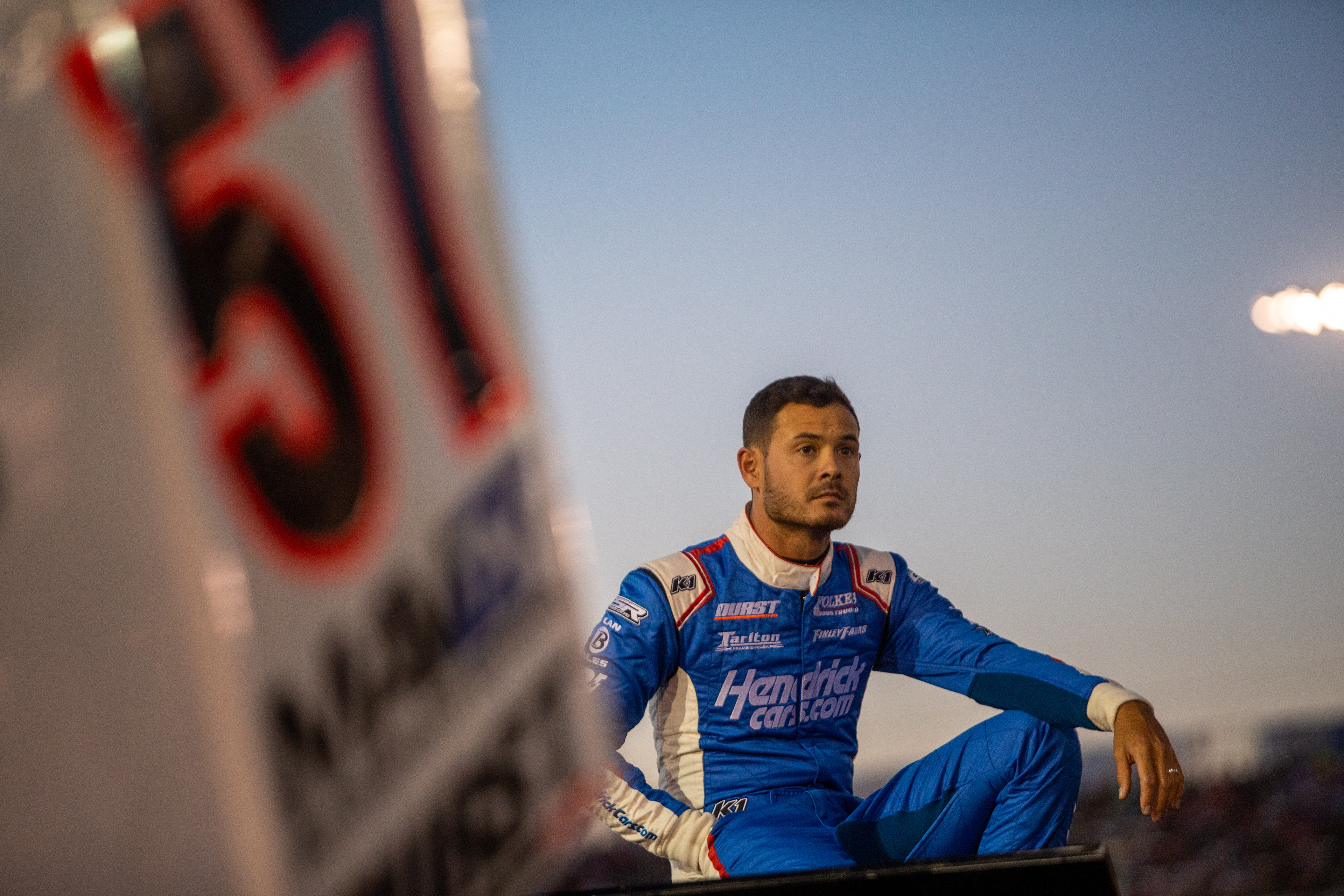 Kyle Larson (57), of Elk Grove, California, watches heat racing action from the pits during the 60th Annual NOS Energy Drink Knoxville Nationals presented by Caseys Championship Night at Knoxville Raceway in Knoxville, Iowa on Saturday, Aug. 14, 2021.