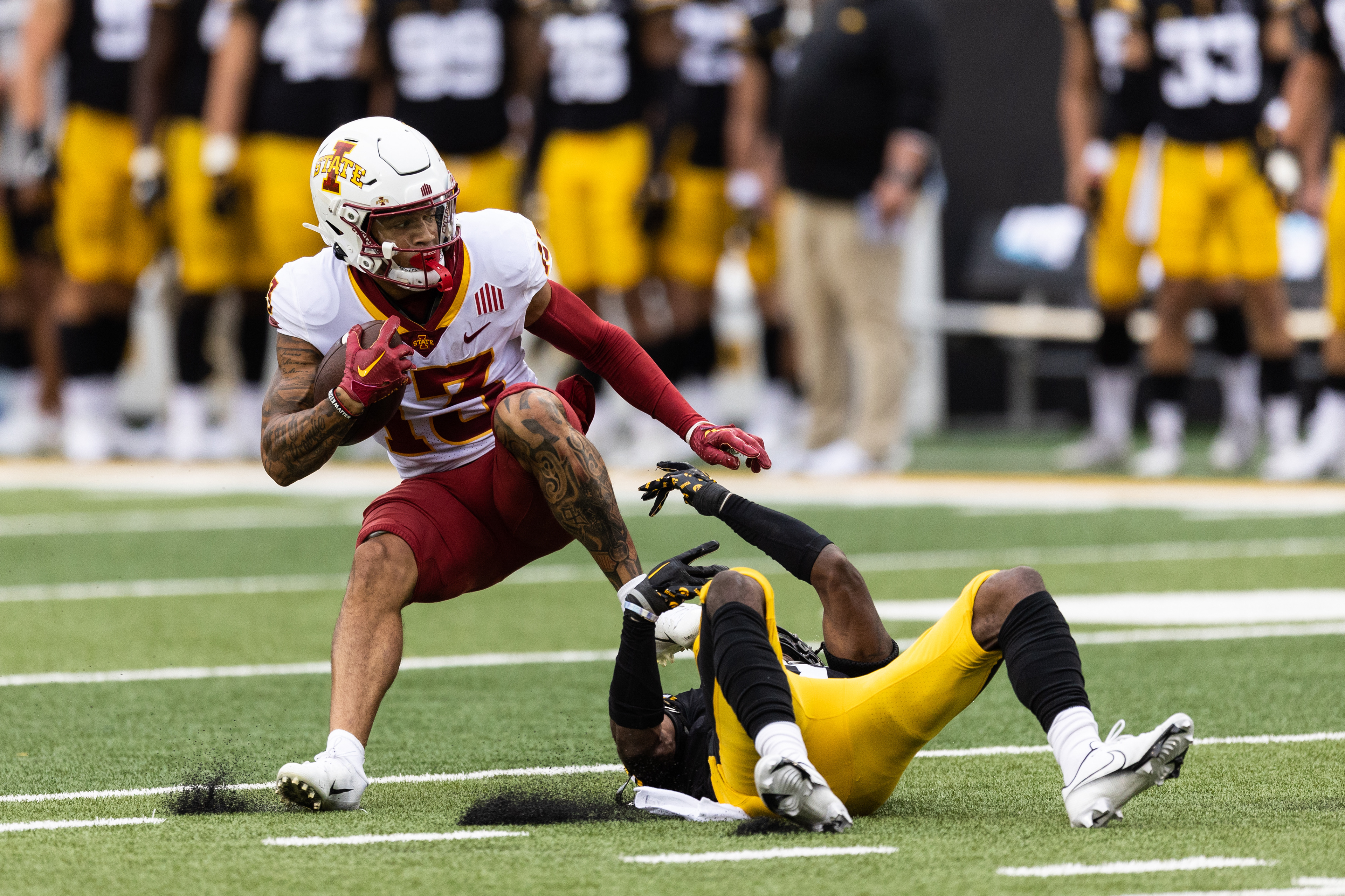 Iowa State Cyclones wide receiver Jaylin Noel (13) is tackled by Iowa Hawkeyes defensive back Terry Roberts (2) during a NCAA football game between the Iowa Hawkeyes and the Iowa State Cyclones at Kinnick Stadium in Iowa City, Iowa on Saturday, Sept. 10, 2022.
