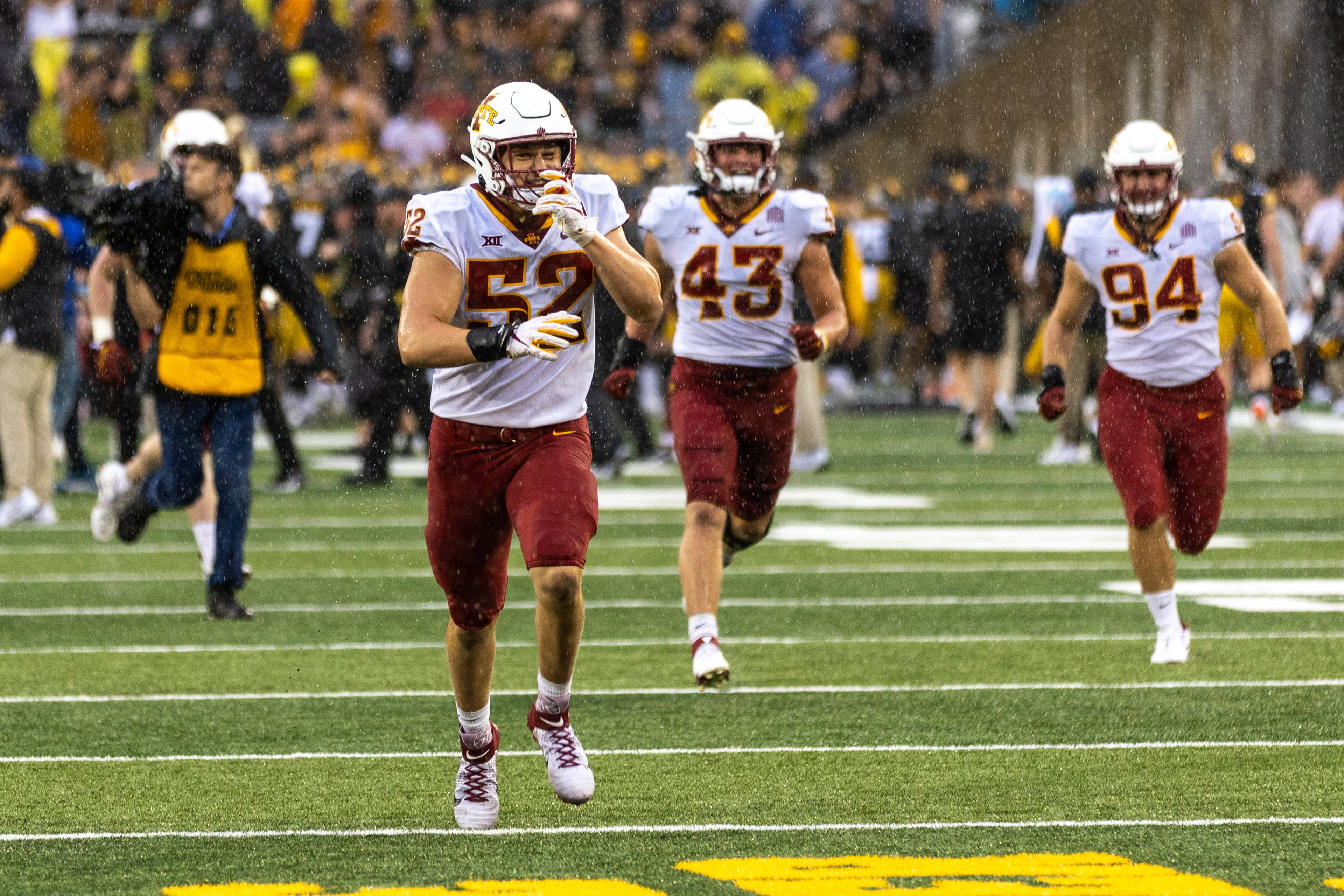 Iowa State Cyclones offensive lineman Trevor Downing (52) runs to the Cy-Hawk Trophy during a NCAA football game between the Iowa Hawkeyes and the Iowa State Cyclones at Kinnick Stadium in Iowa City, Iowa on Saturday, Sept. 10, 2022.
