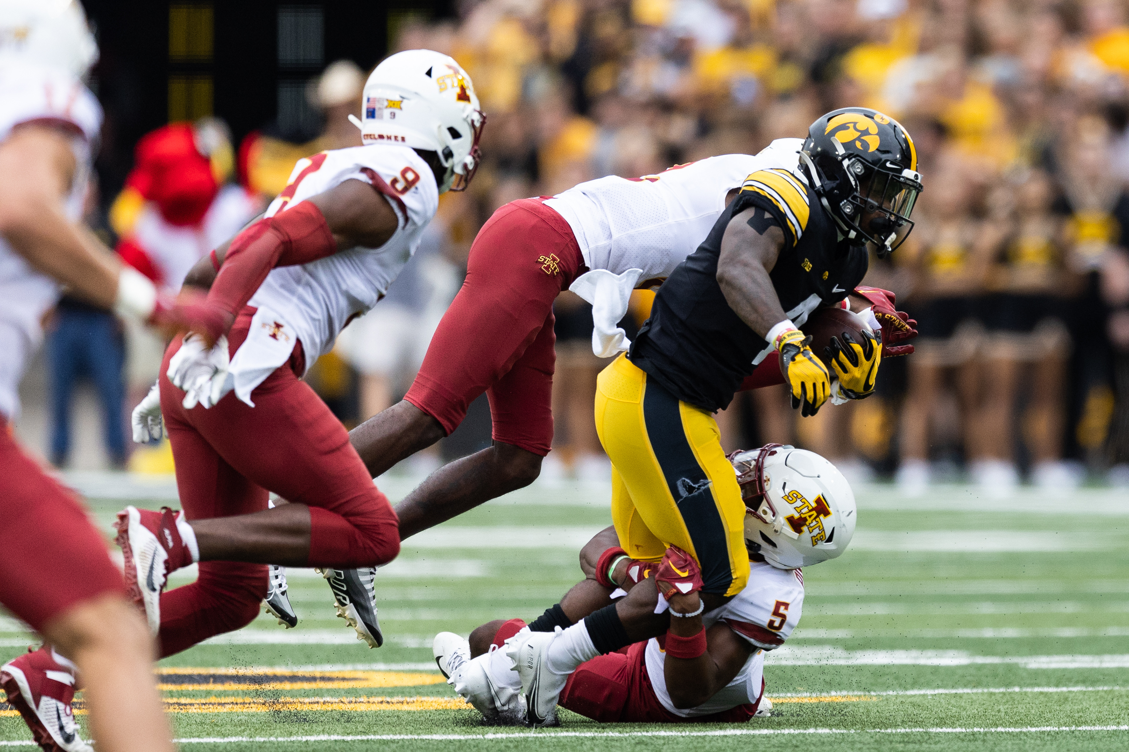 Iowa Hawkeyes running back Leshon Williams (4) is tackled during a NCAA football game between the Iowa Hawkeyes and the Iowa State Cyclones at Kinnick Stadium in Iowa City, Iowa on Saturday, Sept. 10, 2022.