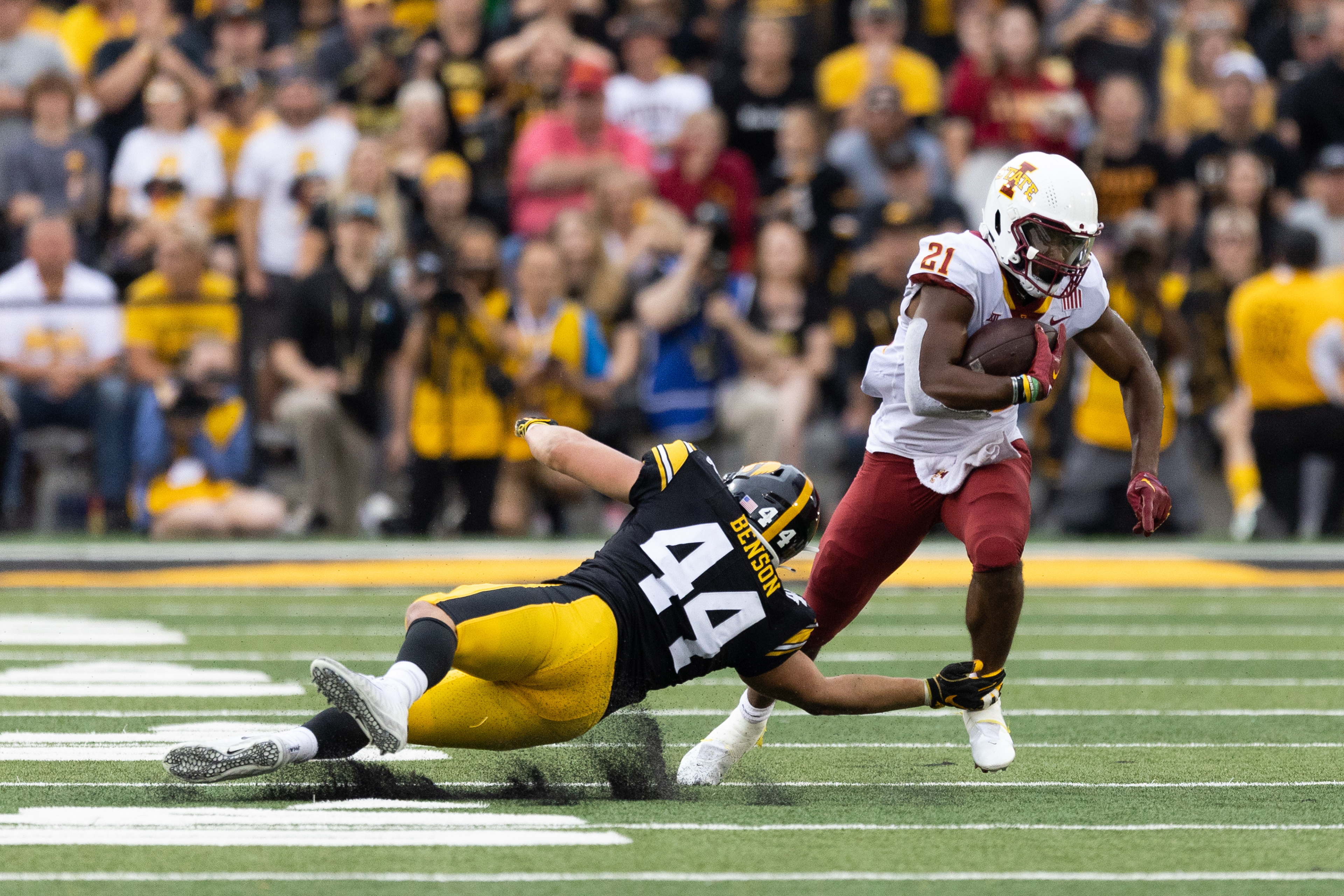 Iowa State Cyclones running back Jirehl Brock (21) runs the ball up field around a diving Iowa Hawkeyes linebacker Seth Benson (44) during a NCAA football game between the Iowa Hawkeyes and the Iowa State Cyclones at Kinnick Stadium in Iowa City, Iowa on Saturday, Sept. 10, 2022.