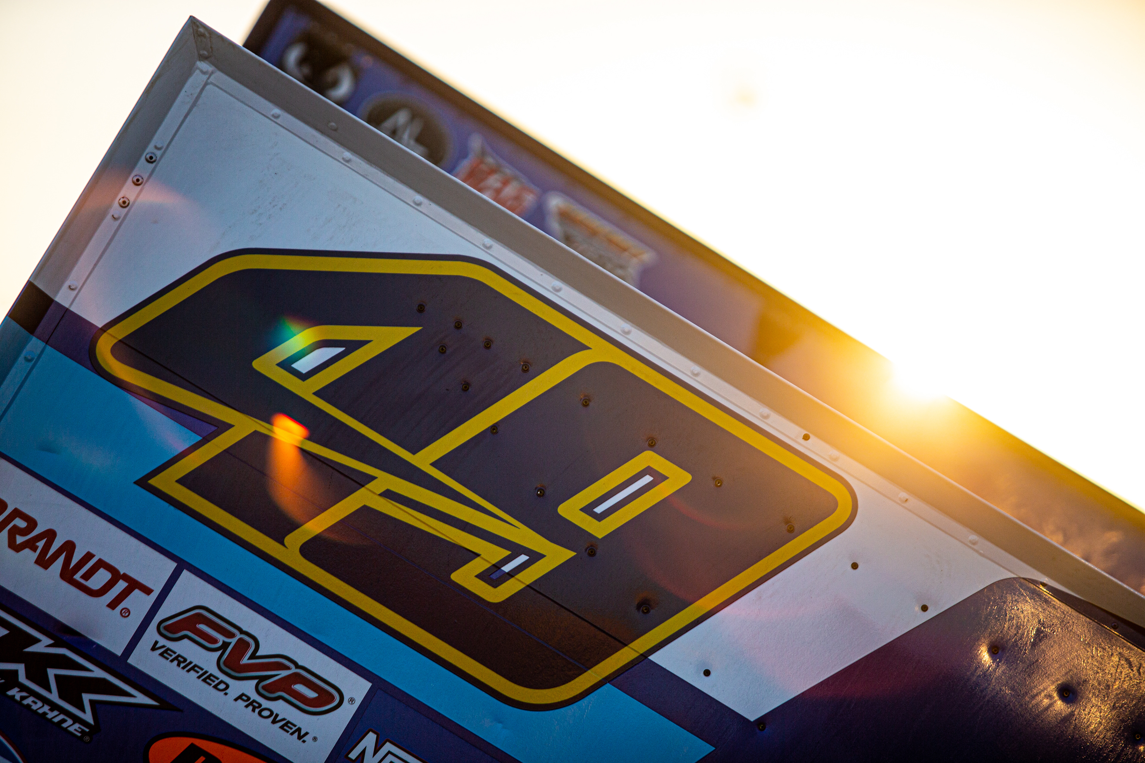 The sun shines behind the wing of Brad Sweet (49), of Grass Valley, California, during the 60th Annual NOS Energy Drink Knoxville Nationals presented by Caseys Championship Night at Knoxville Raceway in Knoxville, Iowa on Saturday, Aug. 14, 2021.
