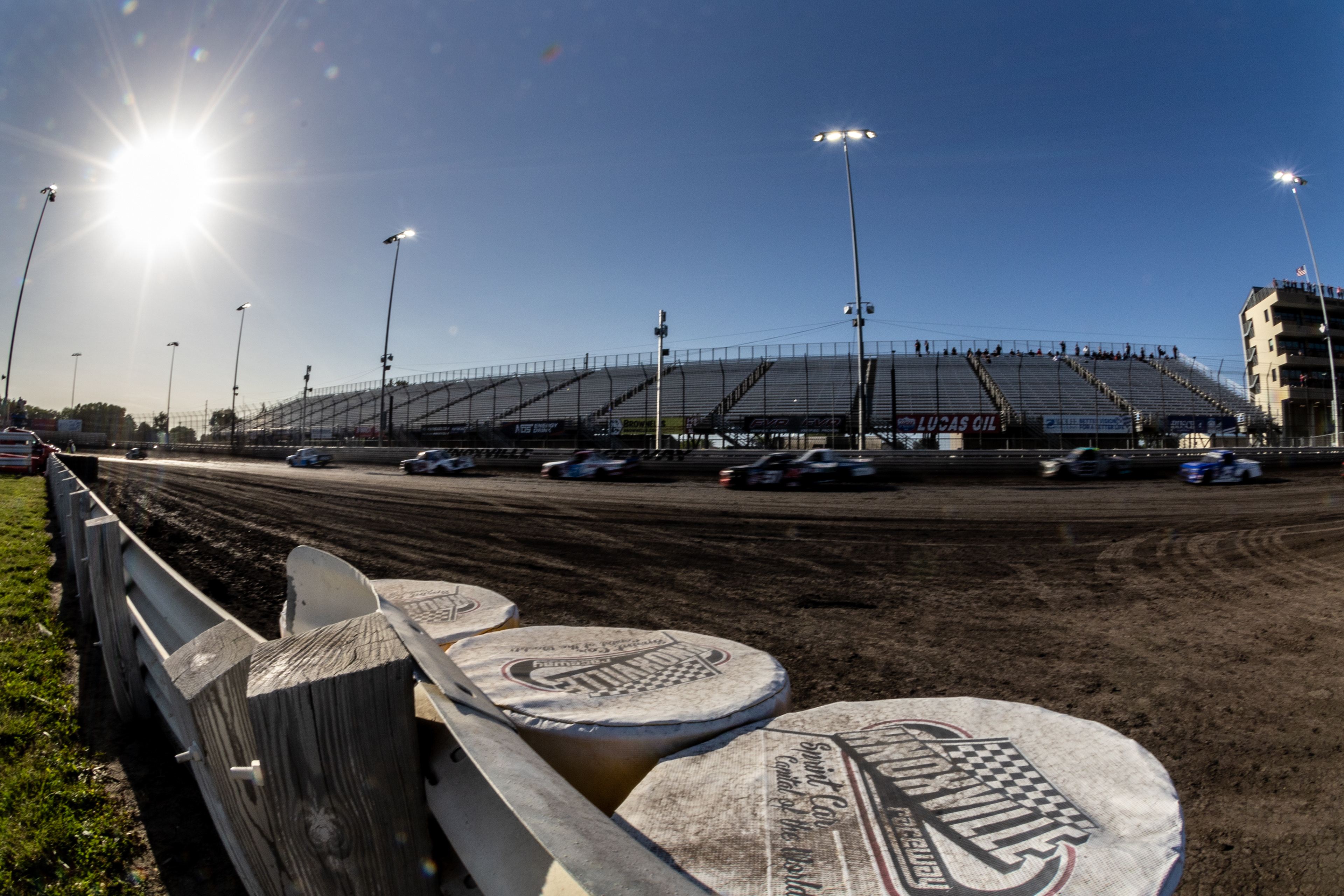 Trucks pass down the backstretch during qualifying for the Clean Harbors 150 NASCAR Camping World Truck Series Race at Knoxville Raceway in Knoxville, Iowa on Saturday, June 18, 2022.