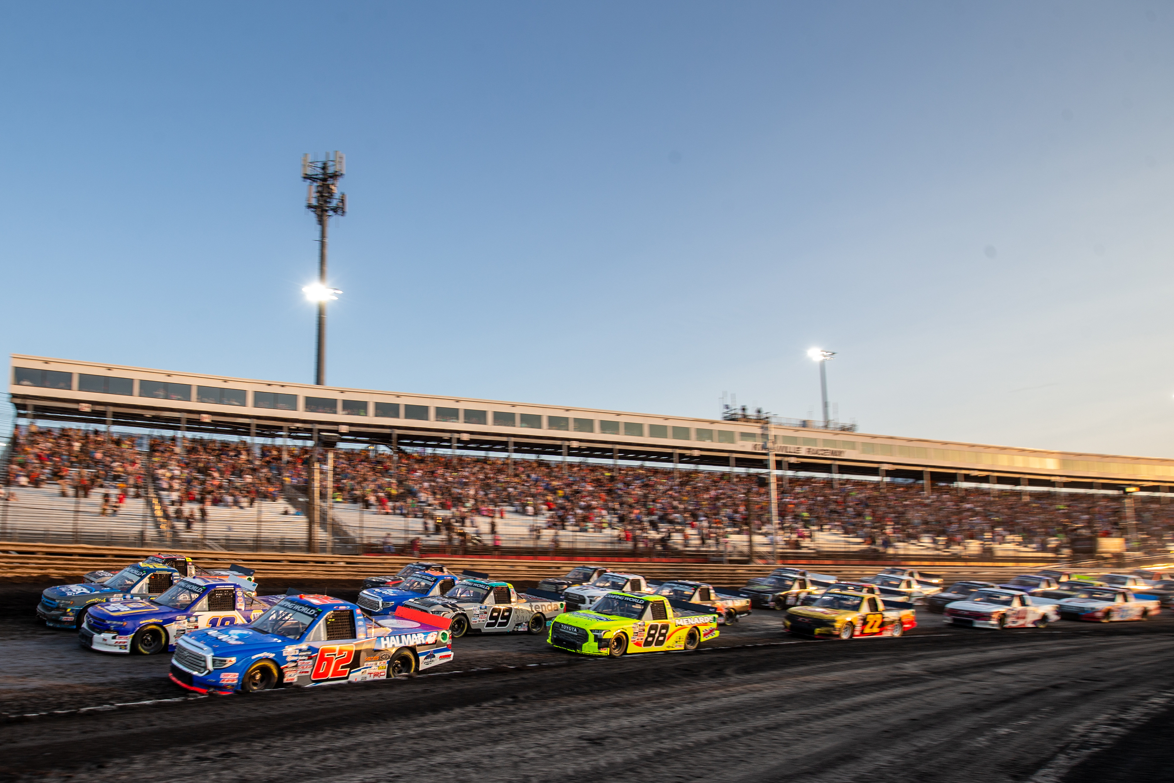 Drivers line up four-wide to salute the crowd during the Clean Harbors 150 NASCAR Camping World Truck Series Race at Knoxville Raceway in Knoxville, Iowa on Saturday, June 18, 2022.