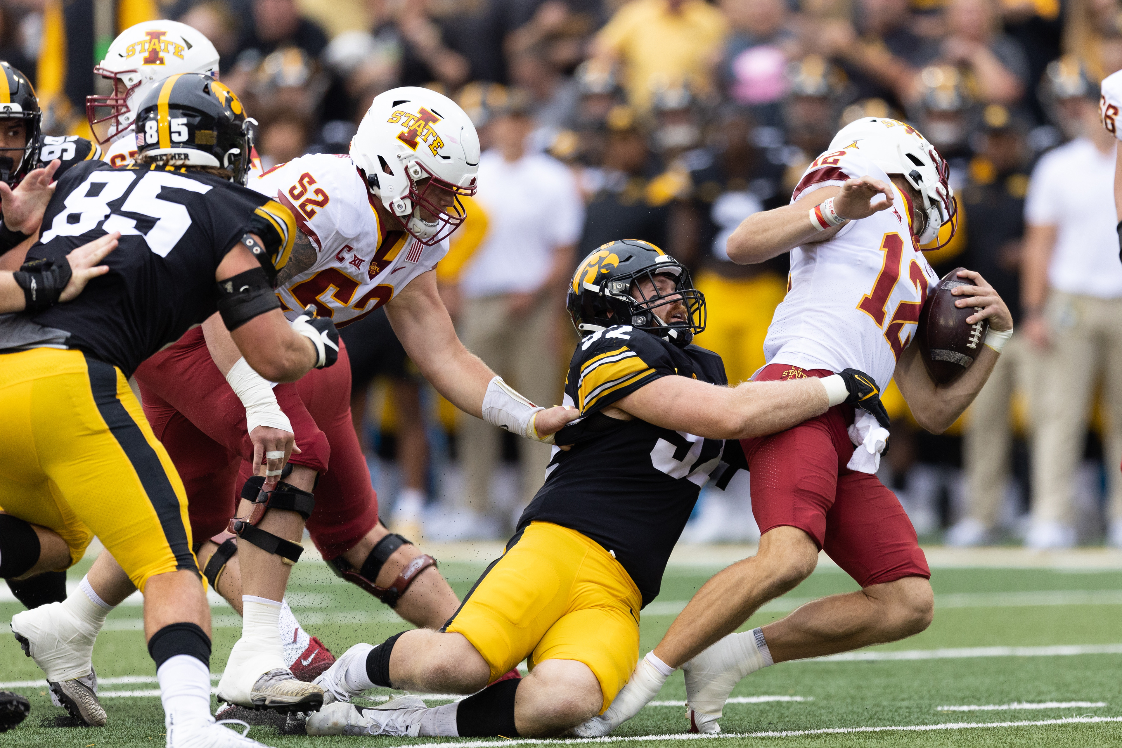 Iowa State Cyclones quarterback Hunter Dekkers (12) is sacked by Iowa Hawkeyes defensive lineman John Waggoner (92) during a NCAA football game between the Iowa Hawkeyes and the Iowa State Cyclones at Kinnick Stadium in Iowa City, Iowa on Saturday, Sept. 10, 2022.