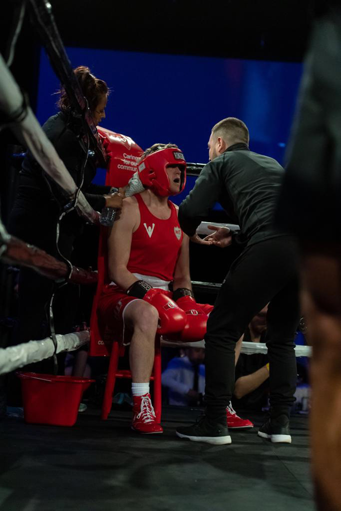 Cornering amateur boxer, Todd to victory.