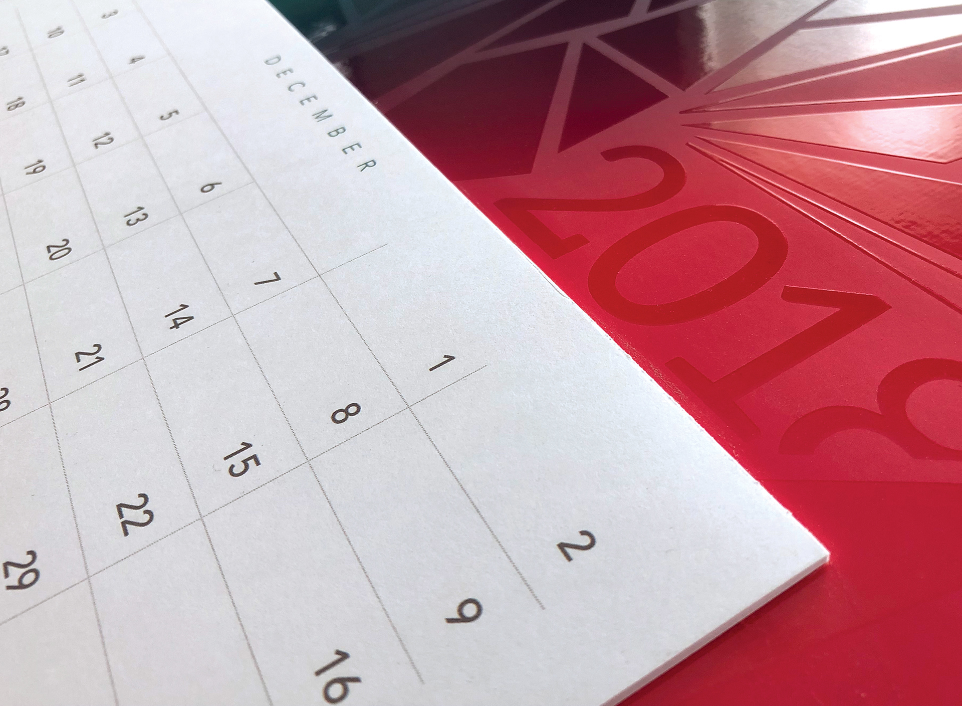 2018 Calendar featuring flood soft touch coating (background) and raised UV