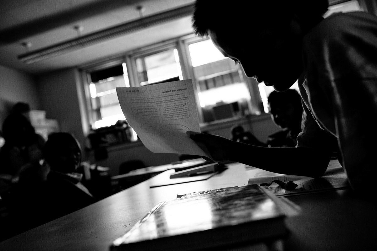 Inside a classroom where lights are off.