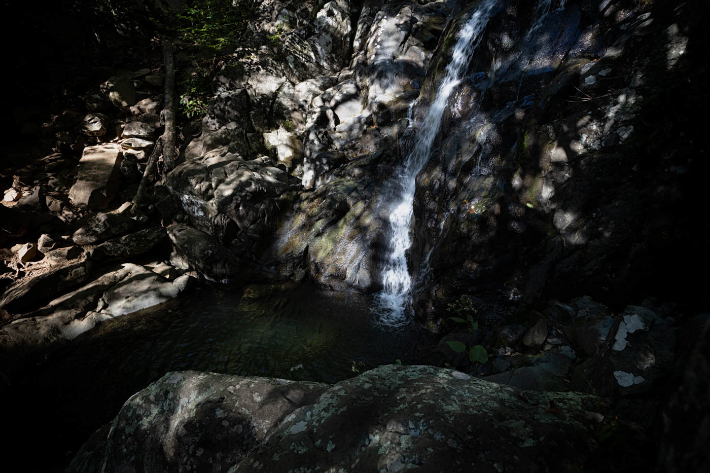 Light peppers Rose River Falls, running slow and exposing much of the rock wall.