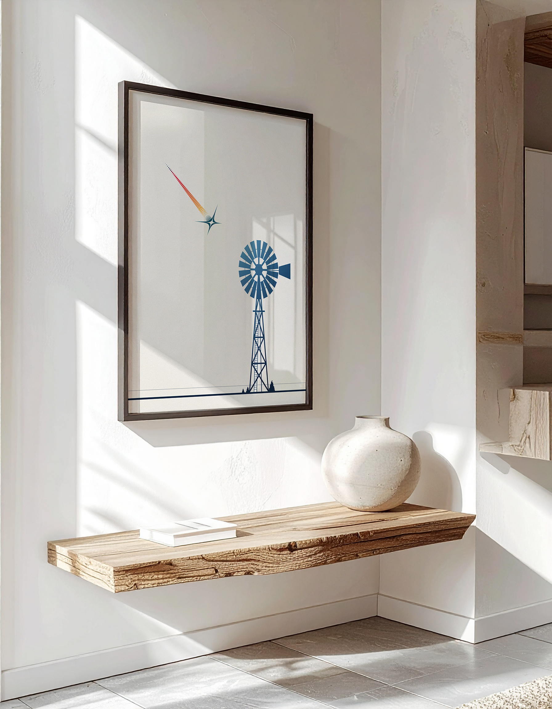 Luxury interior mock-up of the 'Stillness (Before the Spark)' poster in a black frame, hanging above a rustic wooden floating shelf.