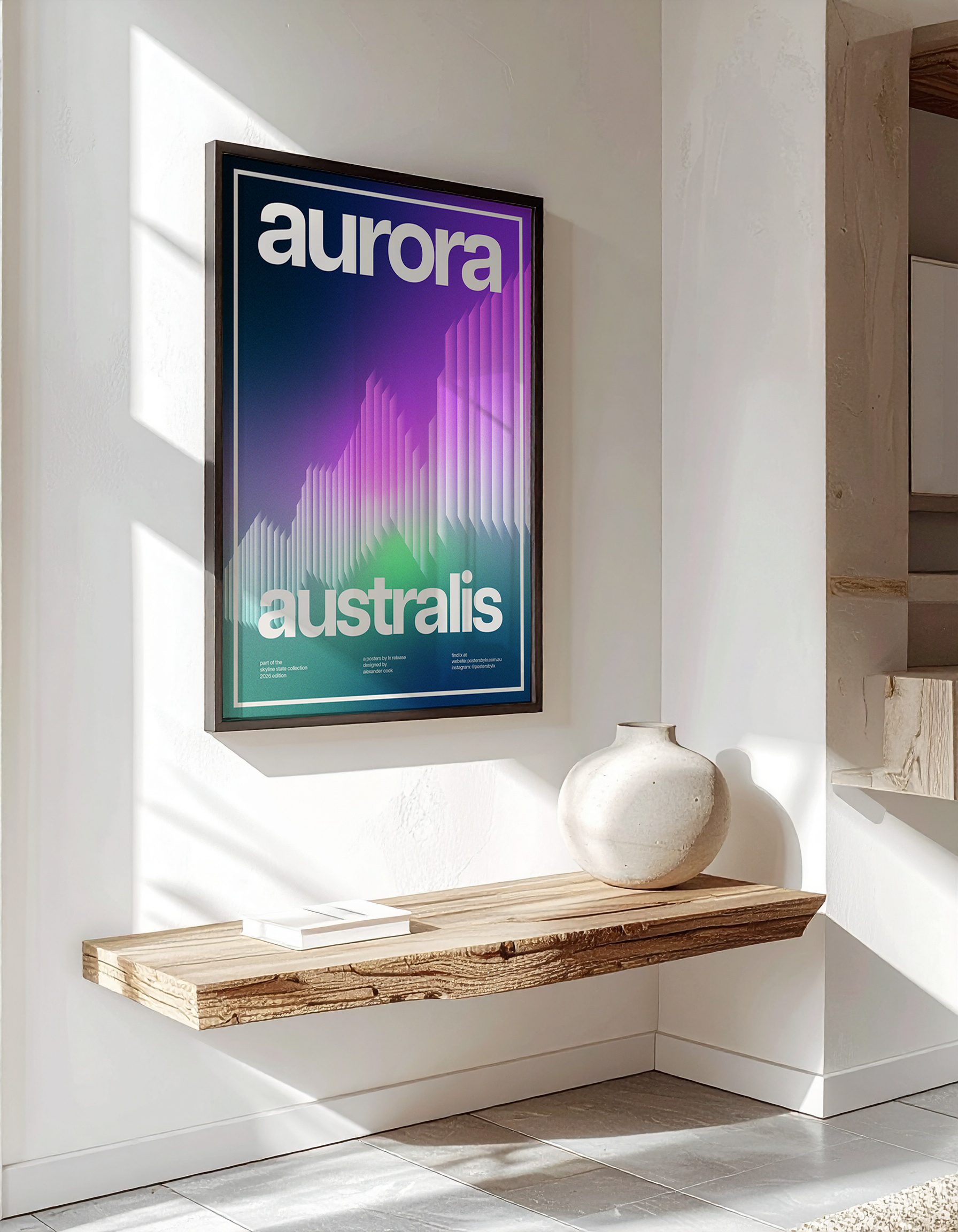 Luxury interior mock-up of the 'Aurora Australis' poster in a black frame, hanging above a rustic wooden floating shelf.