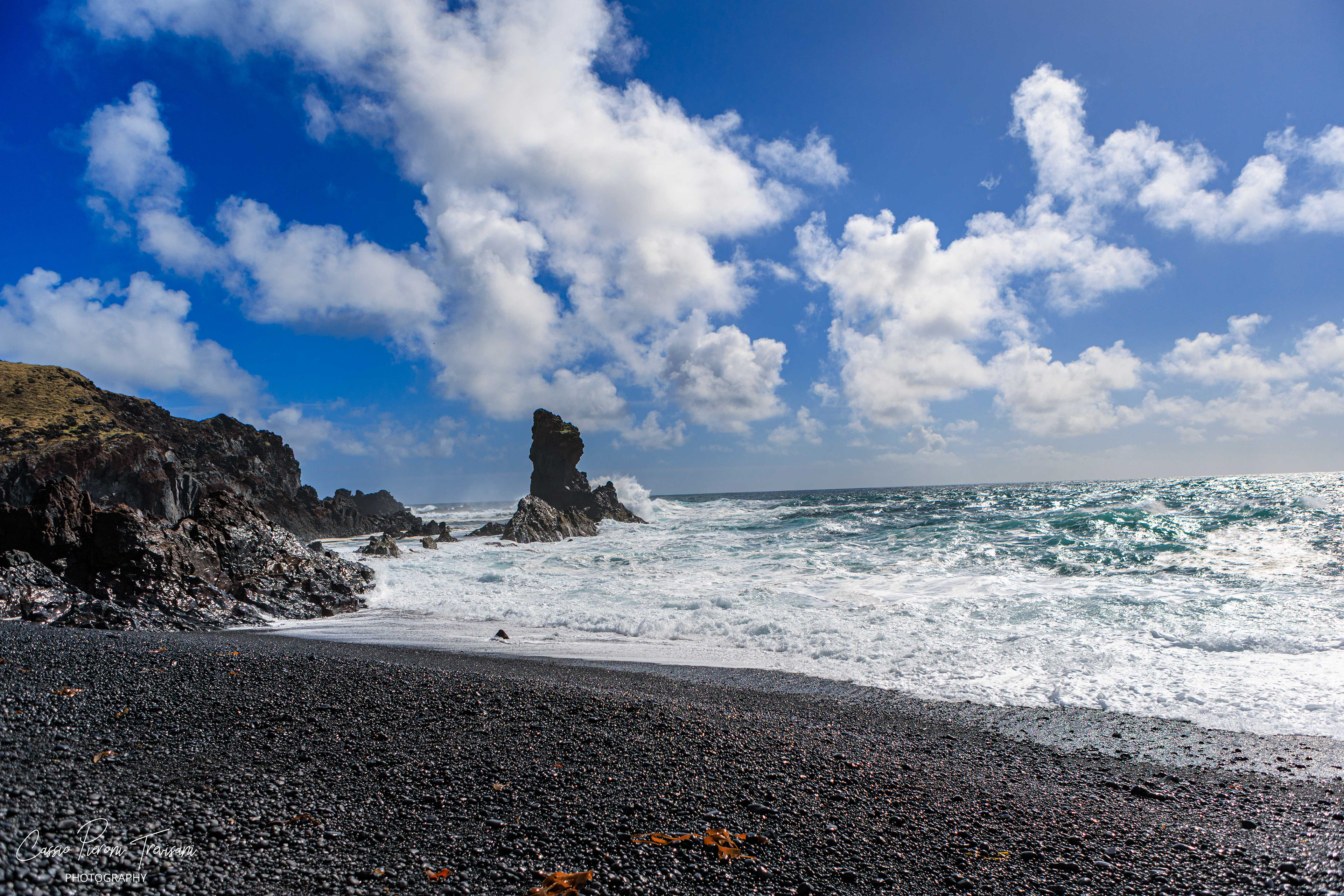 Djúpalónssandur Beach - Bright clouds and foaming waves contrast with the dark volcanic sand, creating a striking view of Iceland’s wild shoreline.