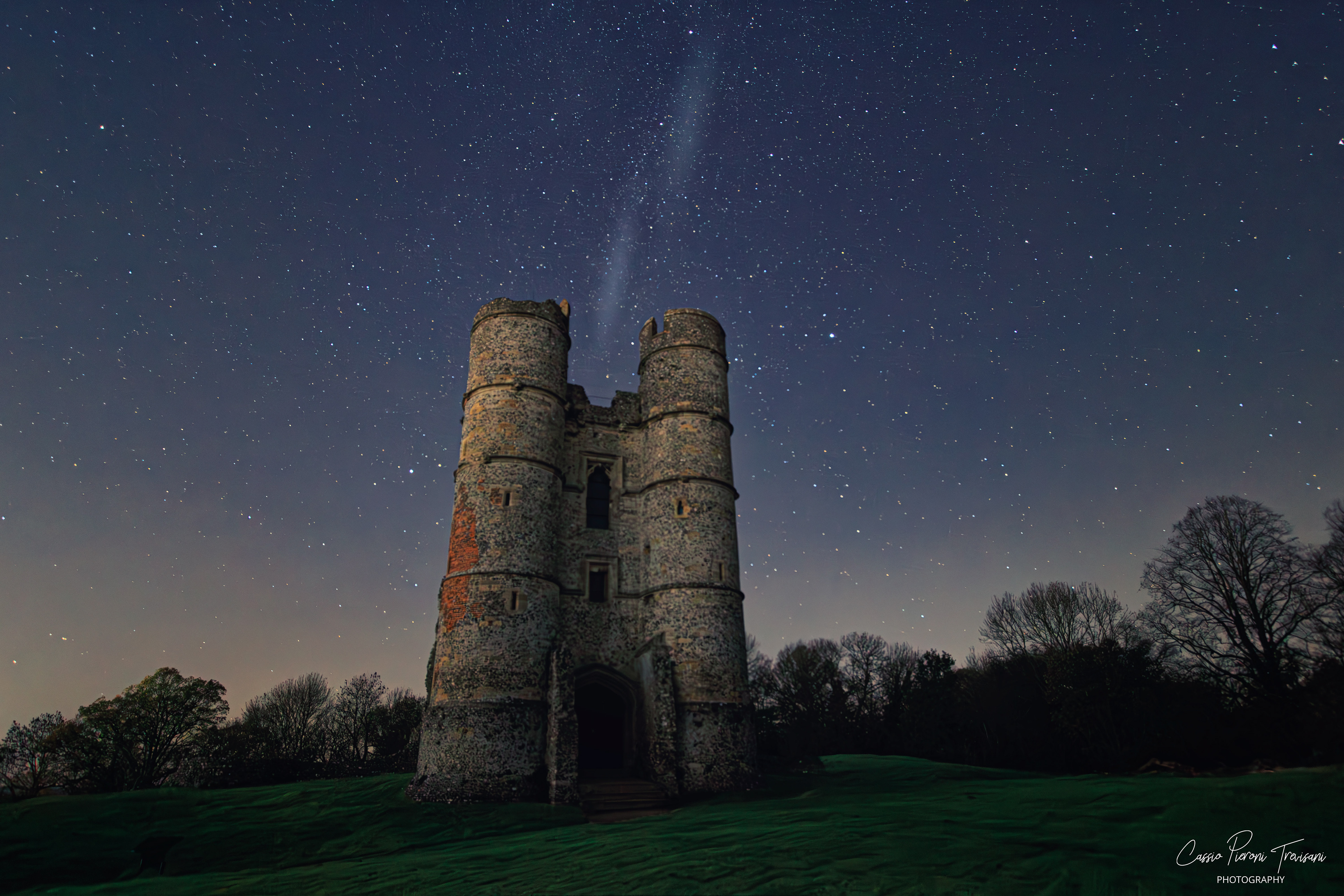 Donnington Castle at night with bright stars overhead and long-exposure sky detail.