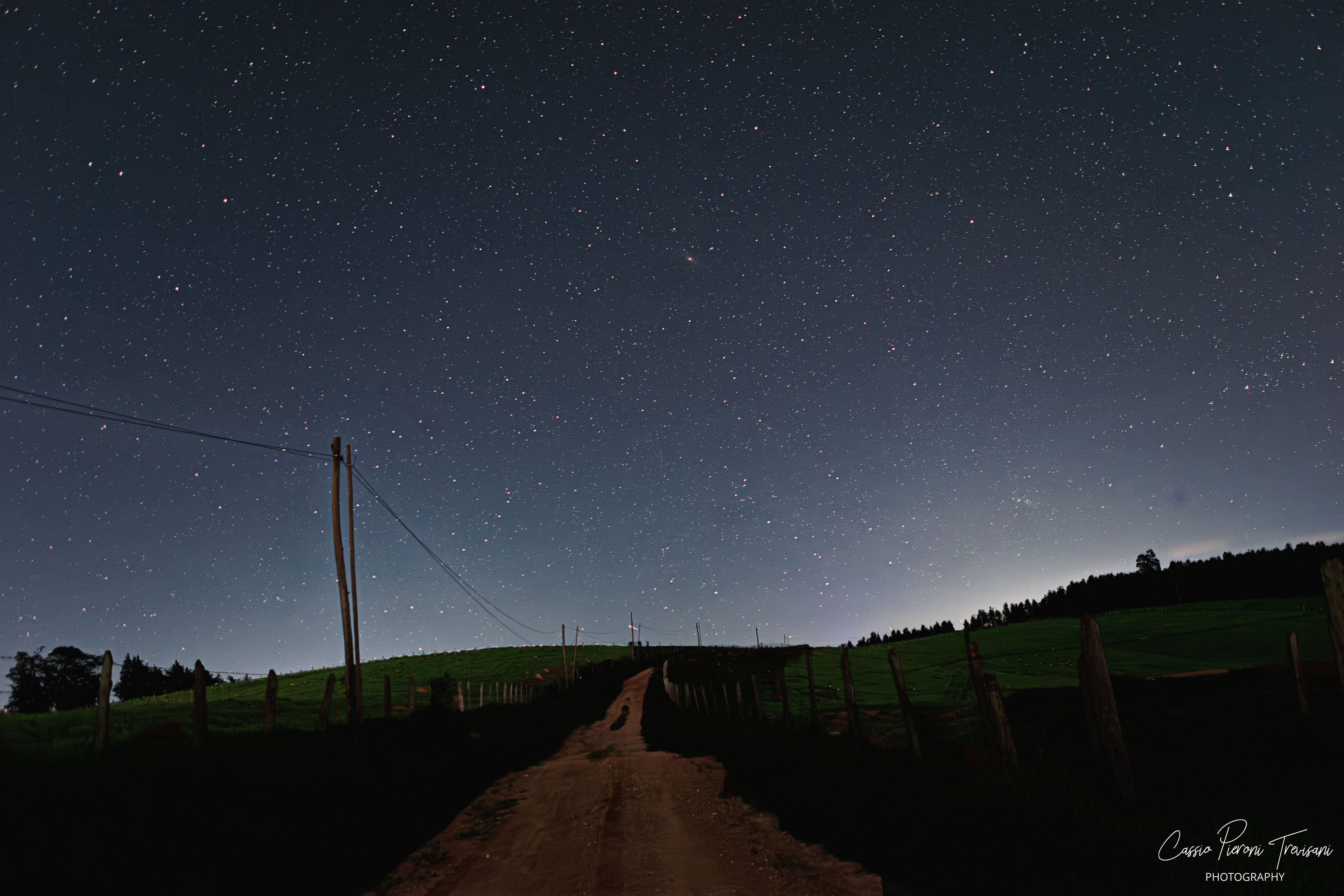 Starry night over a rural dirt road in Jacutinga, Minas Gerais.