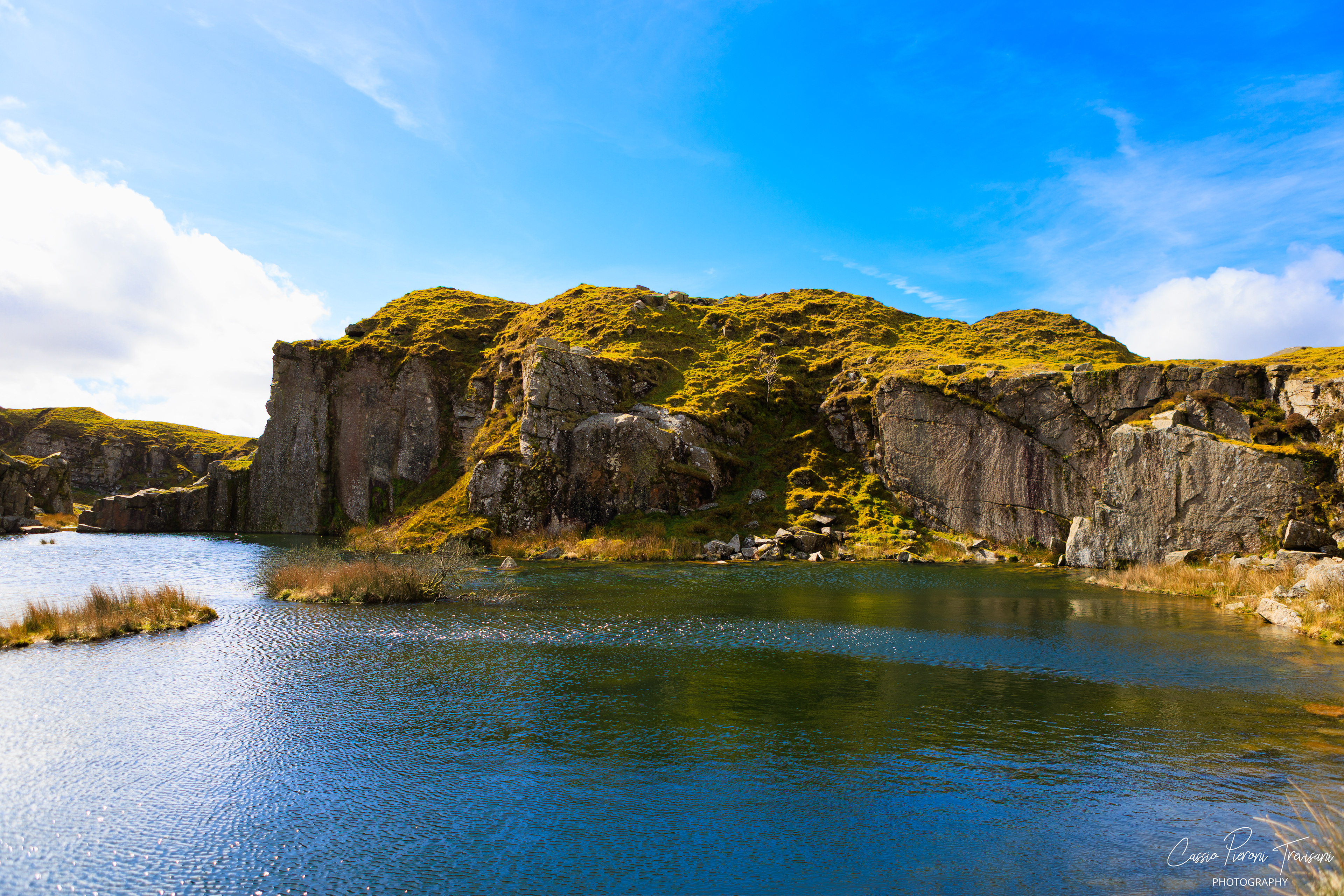 Landscape photographs of Dartmoor National Park featuring rolling moorland, patchwork fields, dry stone walls, wild ponies, rocky outcrops, and historic ruins under dramatic skies.