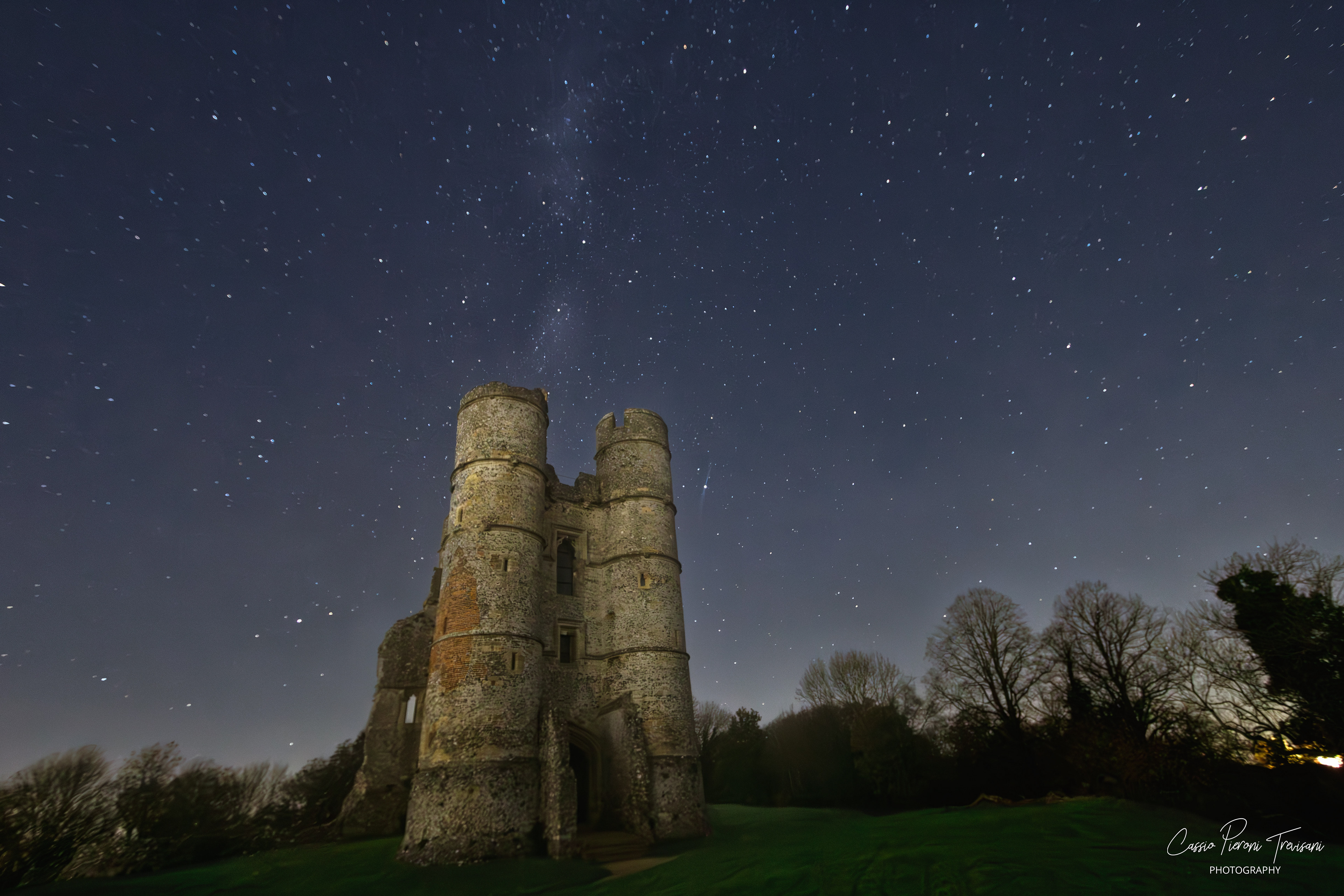 Night photo of Donnington Castle with a faint Milky Way band stretching across the sky.