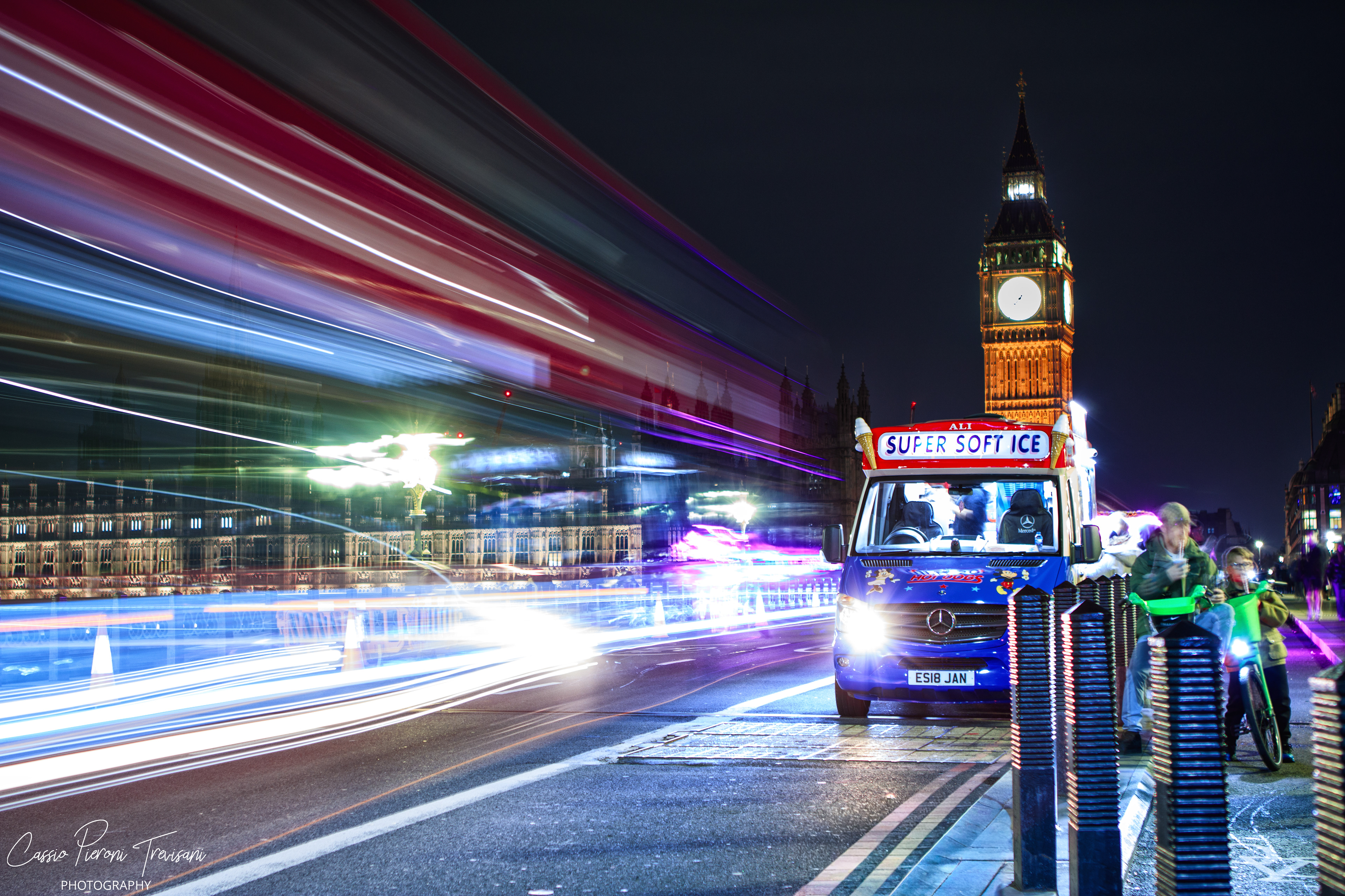 Time stands illuminated at Big Ben as the city blurs into color and motion, a frozen foreground against London’s relentless rhythm.