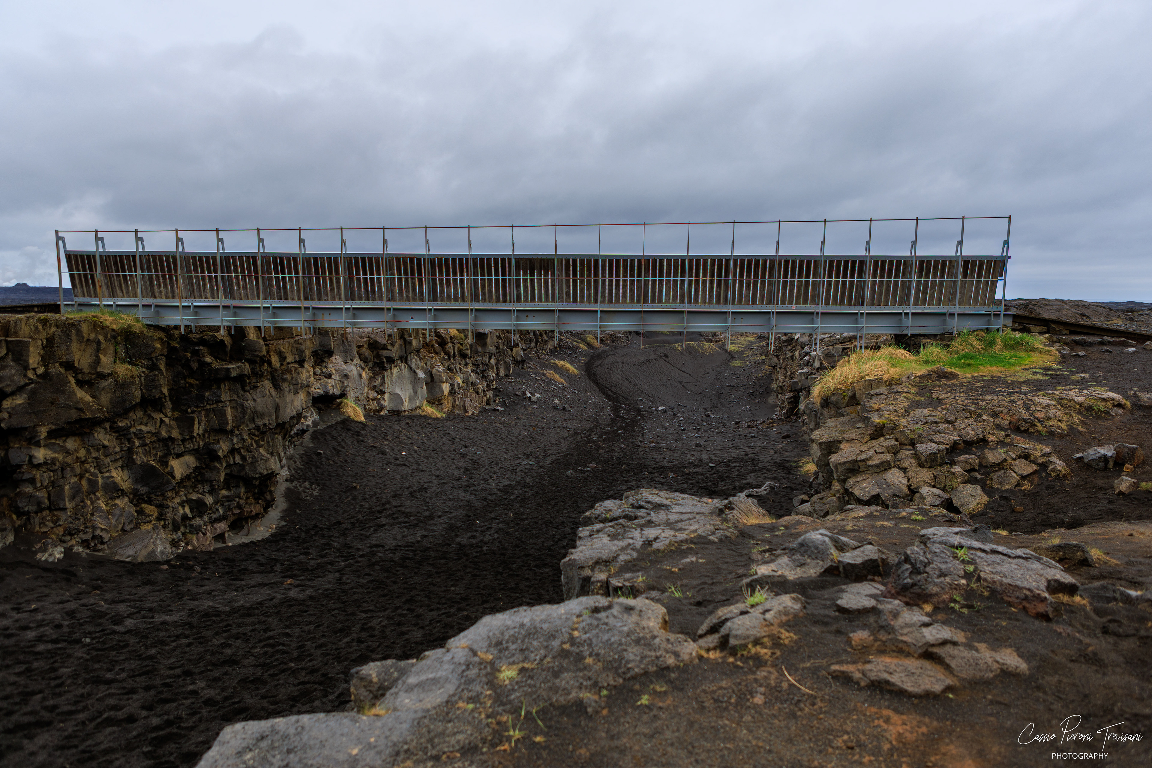 The Bridge Between Continents spans a volcanic fissure at Sandvík, marking the symbolic meeting point of the North American and Eurasian tectonic plates.