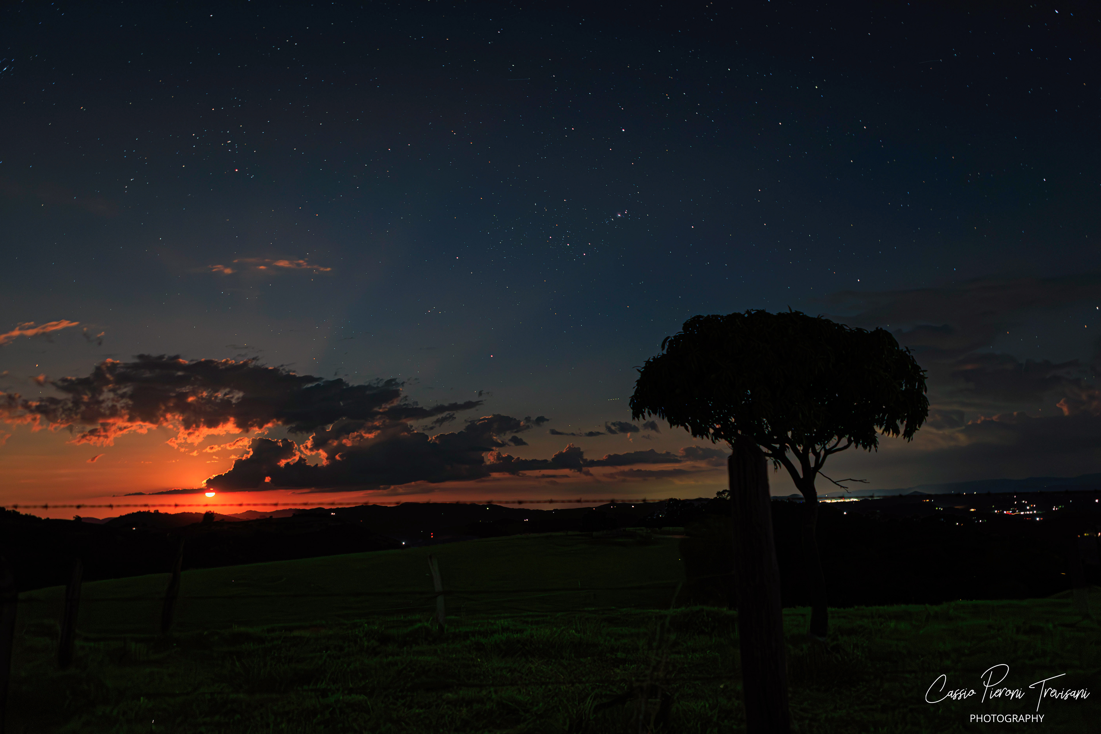 Brilliant supermoon lighting the clouds and landscape of Monte Alto Alegre at night.