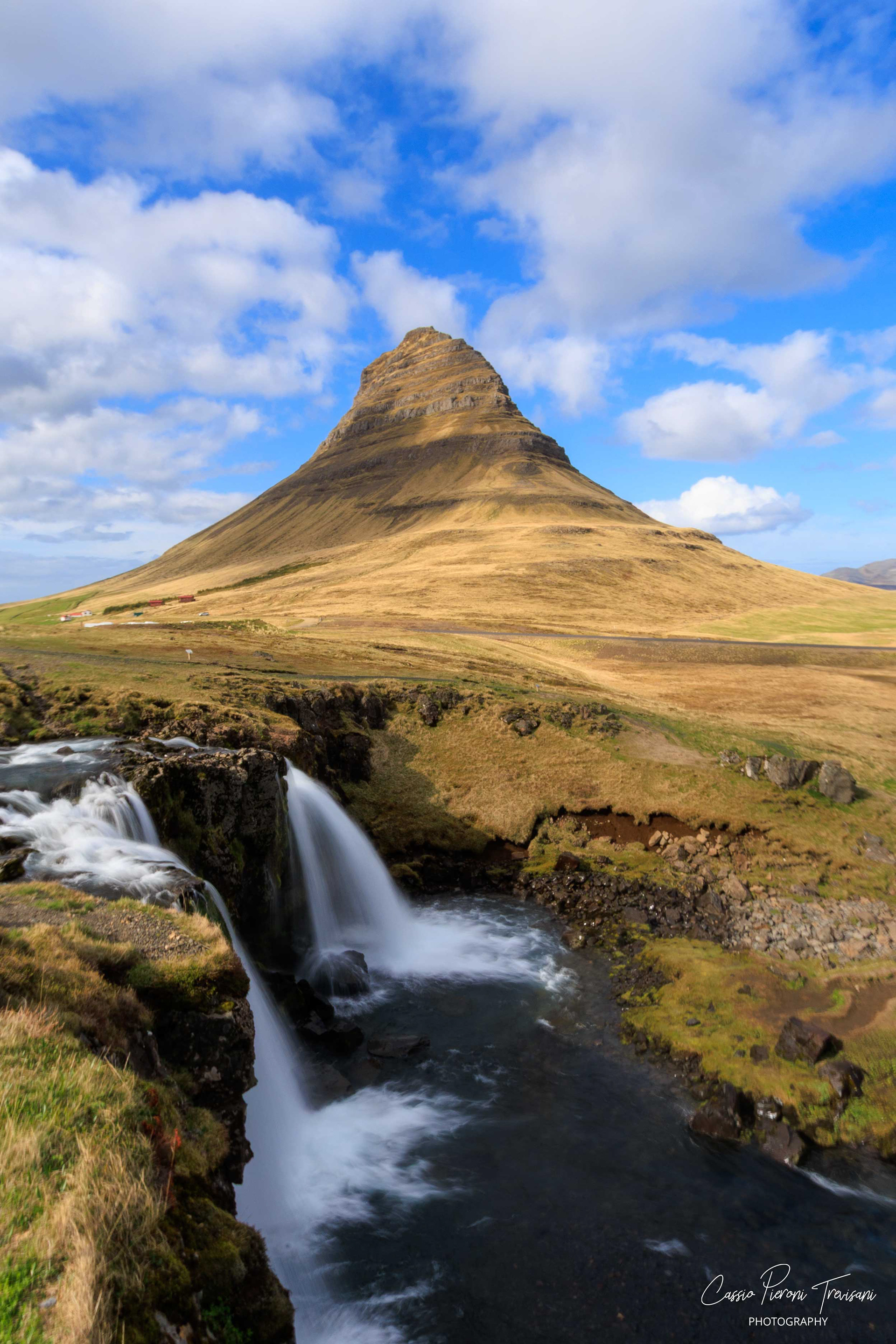 Kirkjufell and the Waterfall - The iconic mountain rises above a flowing waterfall, one of Iceland’s most recognisable views shaped by water, wind, and time.