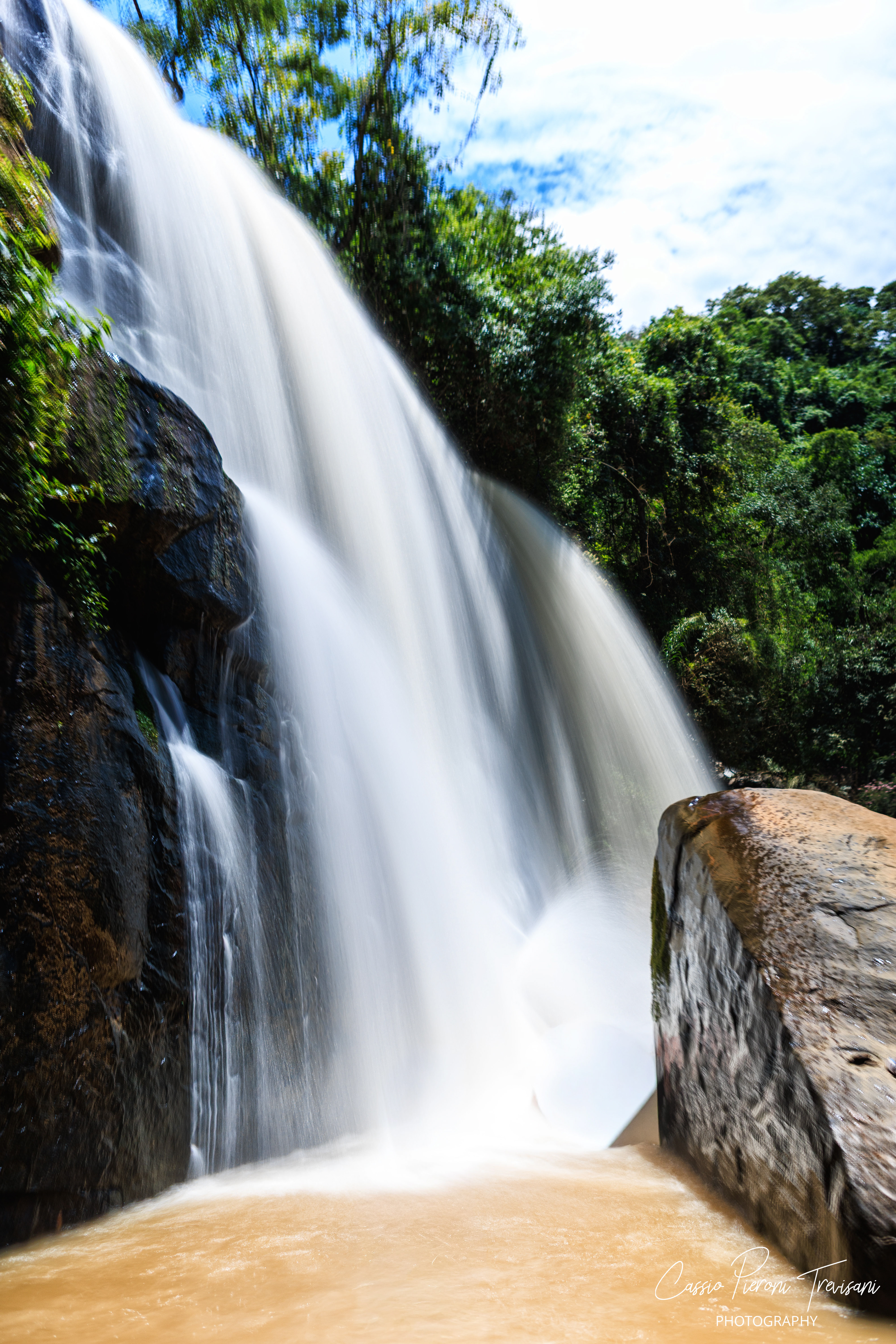 Water thunders over rock at Machado, its movement softened into silk while the surrounding forest stands vivid and alive.
