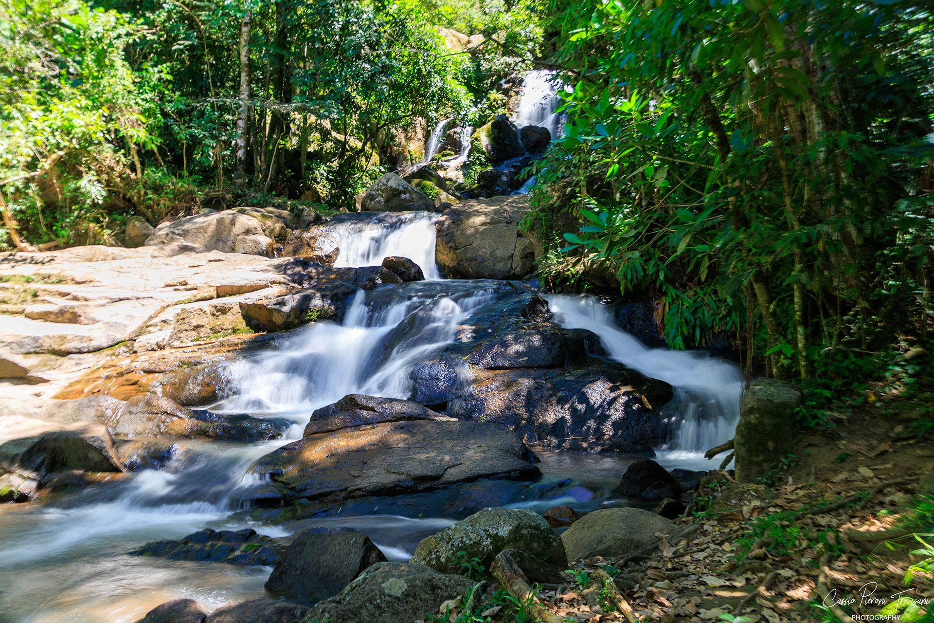 A long exposure transforms the cascading tiers of Waterfall Taboão into a silky flow, framed by rich forest textures and natural light.