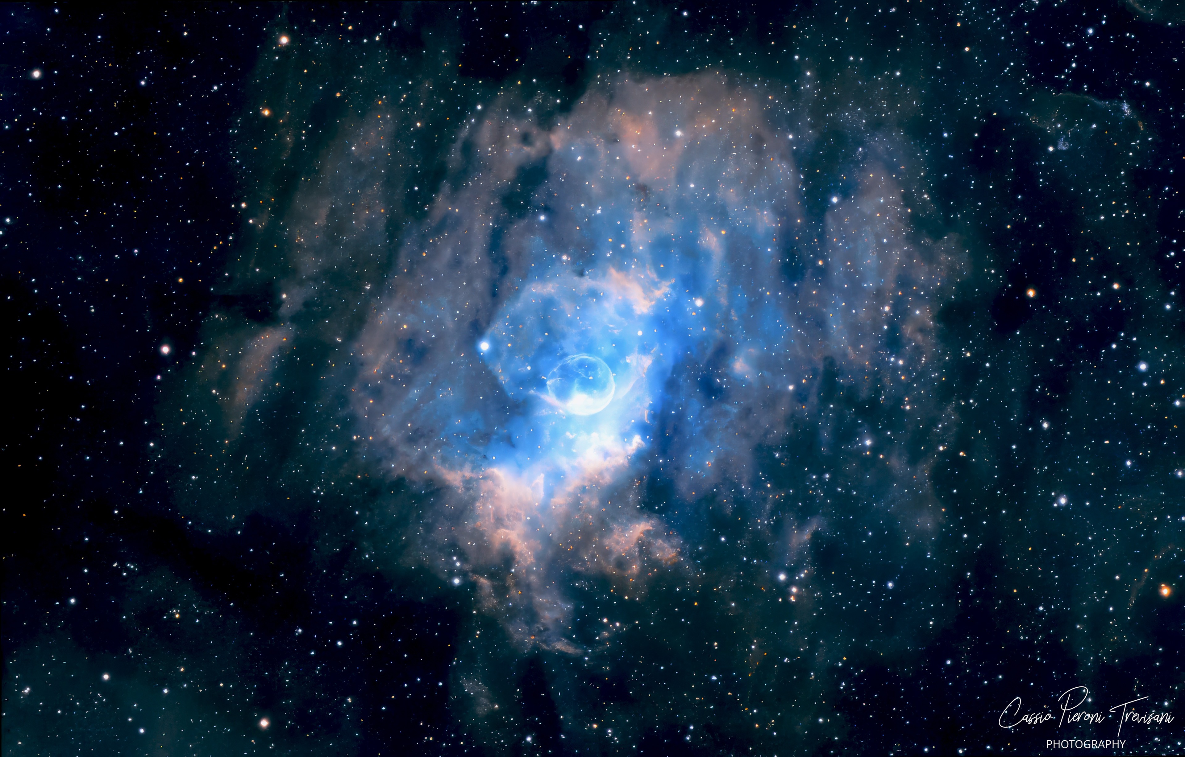 NGC 7635 Bubble Nebula showing a spherical gas bubble created by stellar winds, surrounded by colorful clouds of ionized hydrogen, sulfur, and oxygen in deep space.