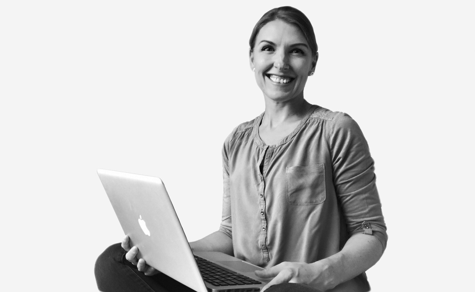 Sarah Webb, freelance graphic designer, sitting with laptop