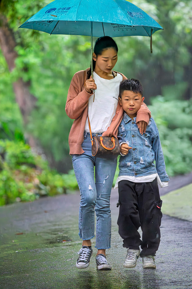 Woman and Child Walking in the Park in the Rain Chengdu