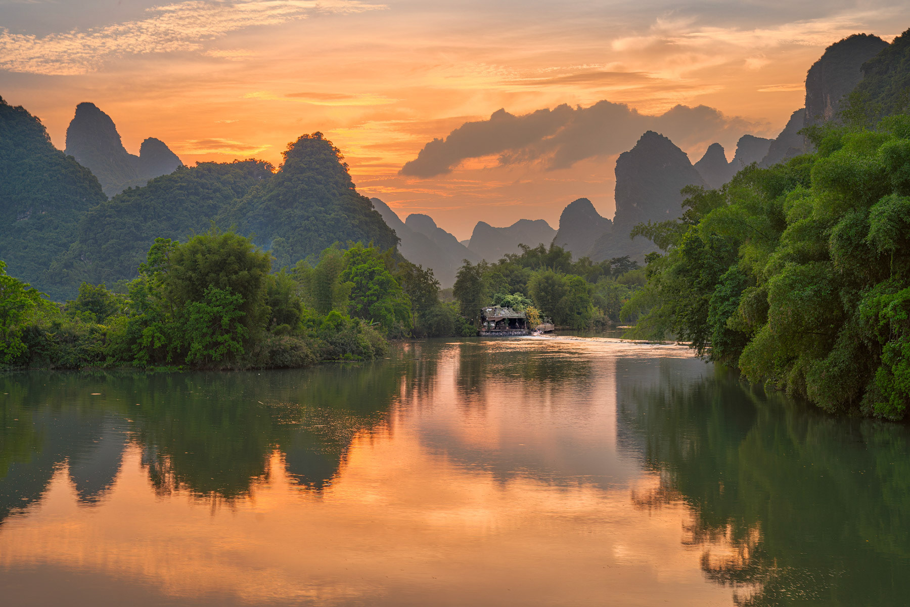 Fisherman's House On Yulong River From Gongrong Bridge At Sunset