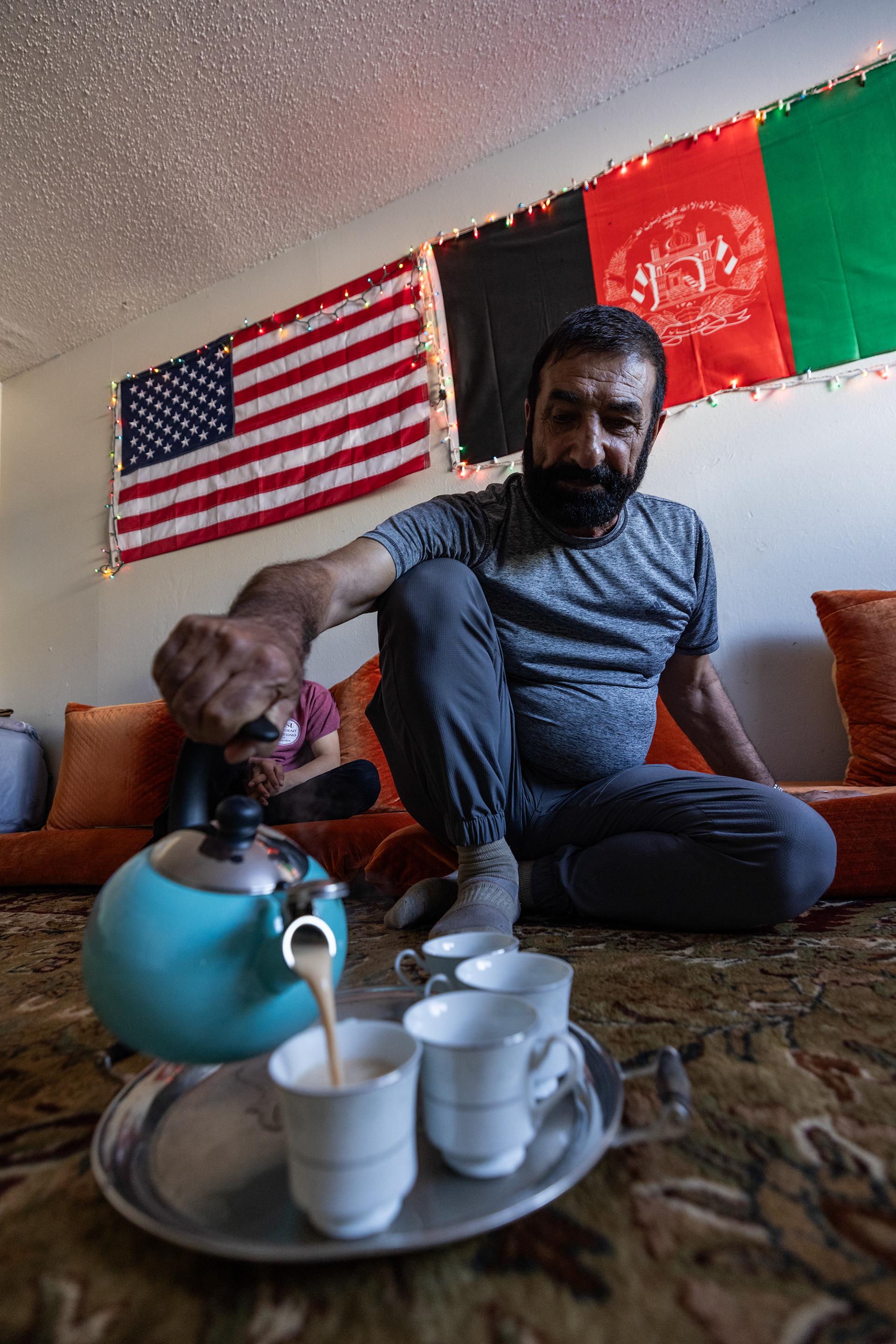 Mohamed Amini, an Afghan refugee who fled Afghanistan following the Taliban takeover, pours milk tea in his apartment living room in Fort Worth on Wednesday, Sept. 27, 2023. Mohamed was part of the armed forces helping Americans when he lived in Afghanistan. His work made him a target for the Taliban which led to him and his family fleeing the country.