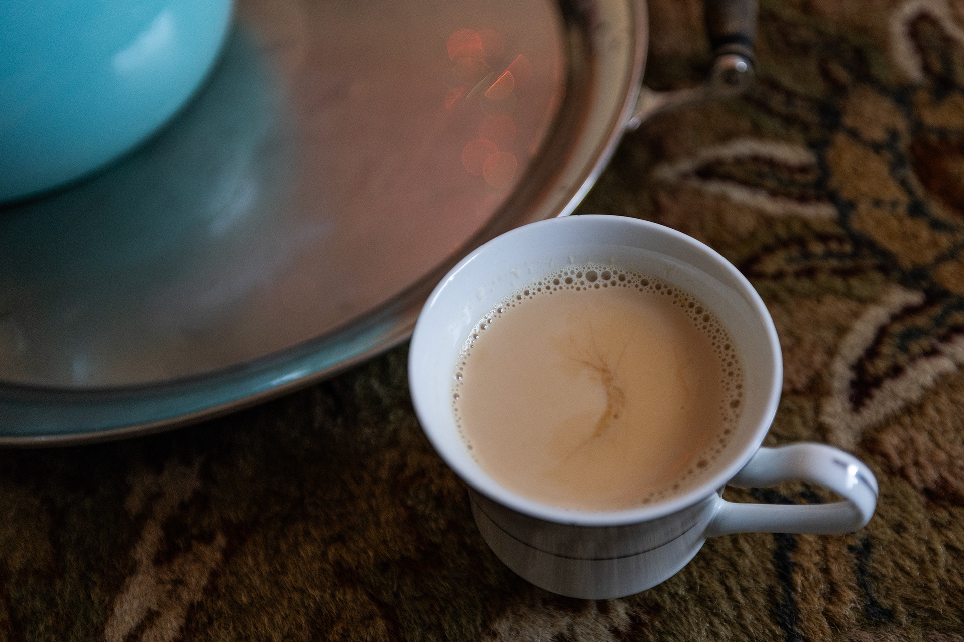 A fresh cup of Sheer Chai Afghan milk tea is poured for guests in Mohamed Amini’s apartment living room in Fort Worth on Wednesday, Sept. 27, 2023.