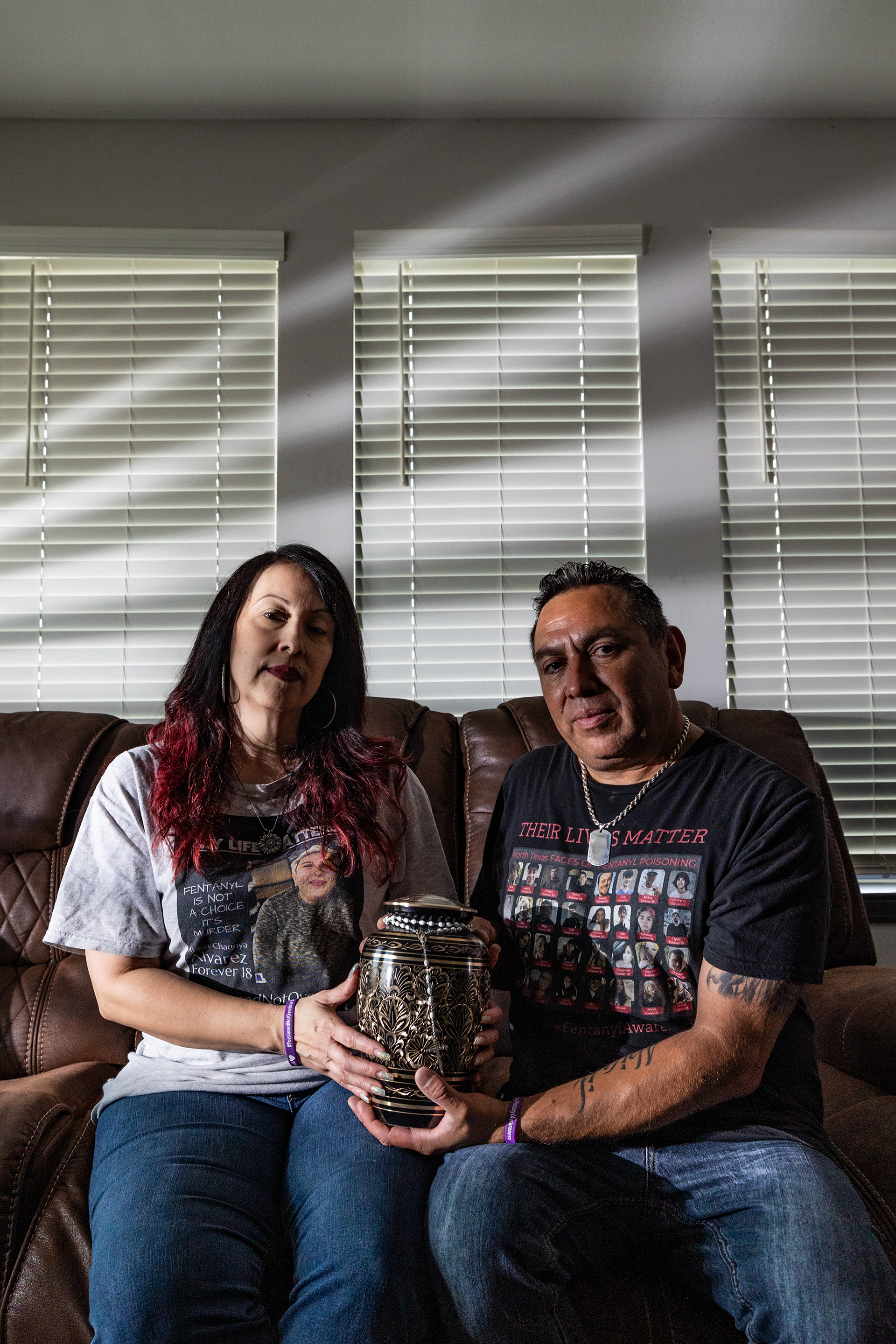 Adolph and Peggy Alvarez hold the urn of their daughter Abagil, who died from a fentanyl overdose on May 14, 2022 at 18 years of age, at their apartment in Fort Worth on Thursday, Aug. 17, 2023. Adolph and Peggy said Abagil was in a room full of people when she overdosed, but was left unconscious for around 11 hours before being found by authorities.