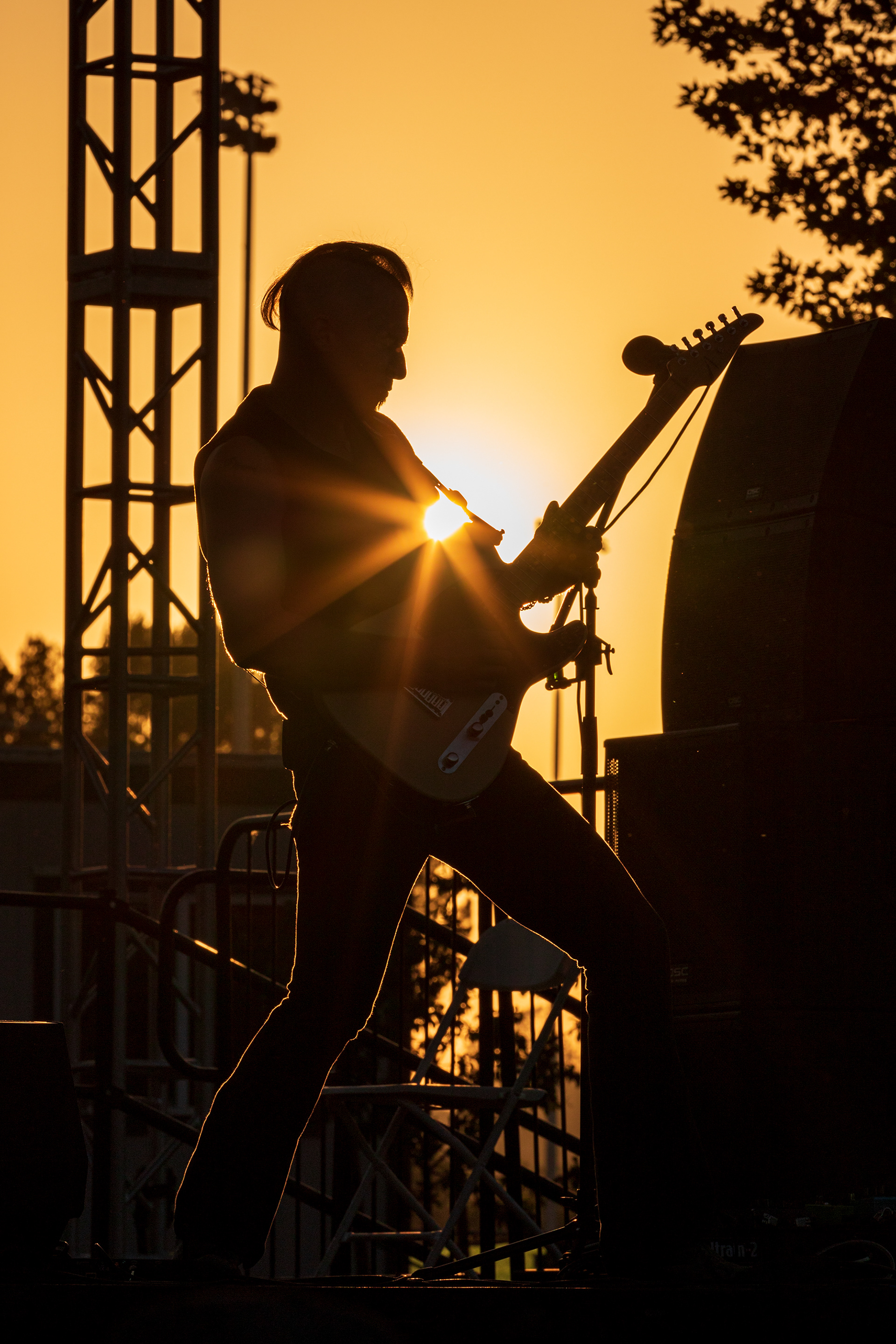 Lead guitarist Aaron Kusterer is silhouetted as he plays his guitar solo during Twisted Gypsy’s performance for this weeks installment of Concerts in the Park at Central Park in Saugus, Calif., on Saturday, Aug. 20, 2022. Chris Torres/The Signal