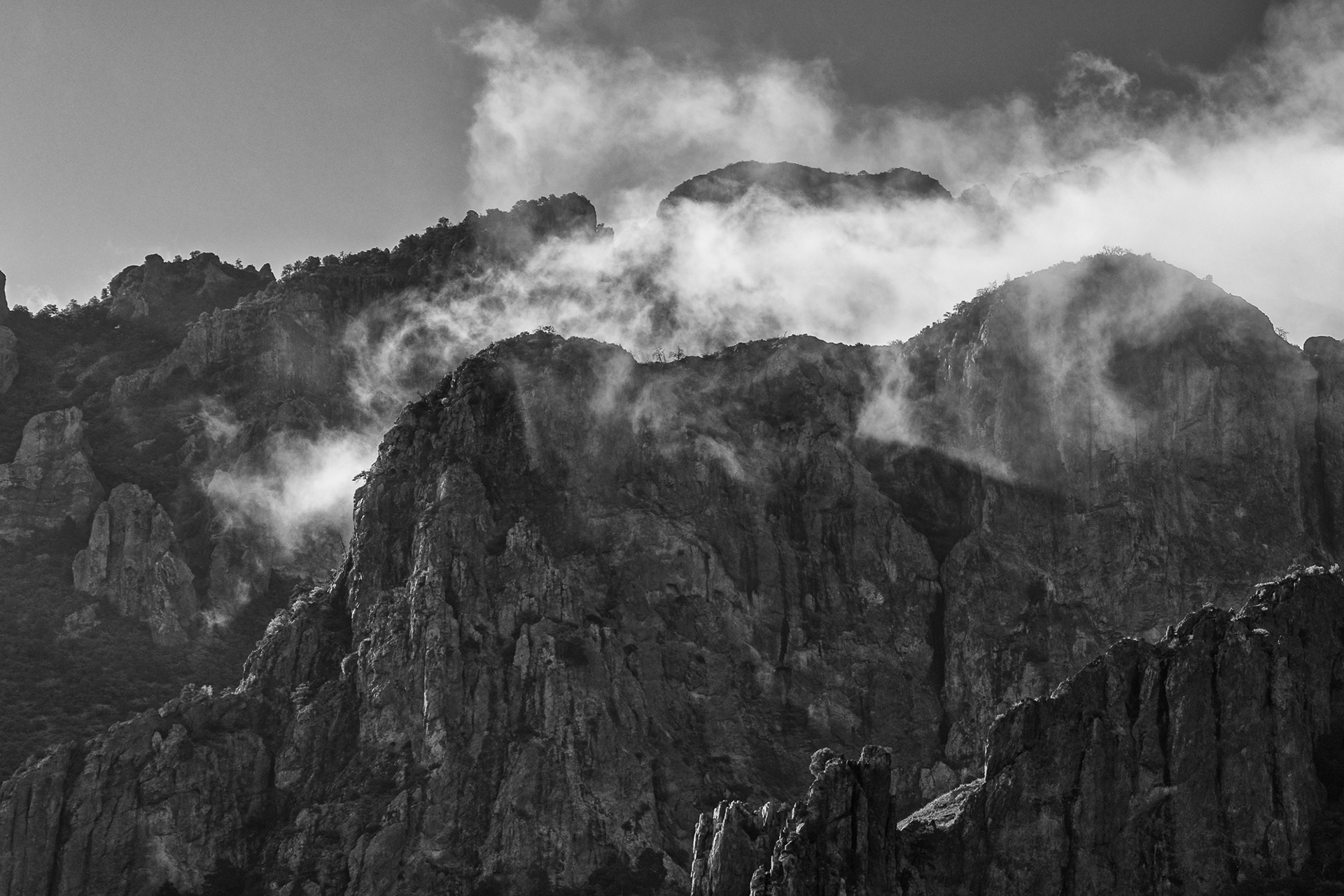 Morning clouds rush through the canyons at Chisos in the morning.