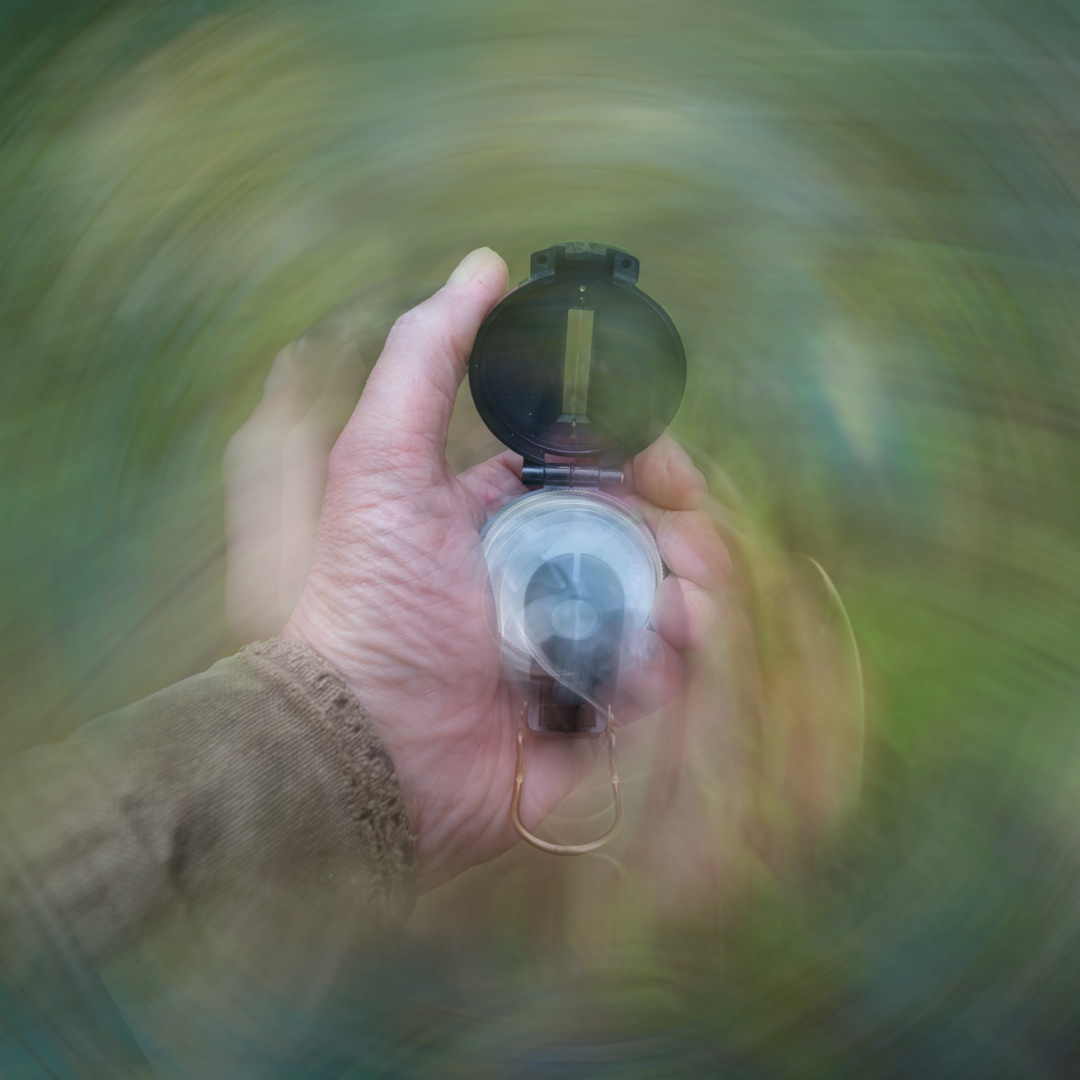 ICM concept image: a person lost in the woods using a compass.