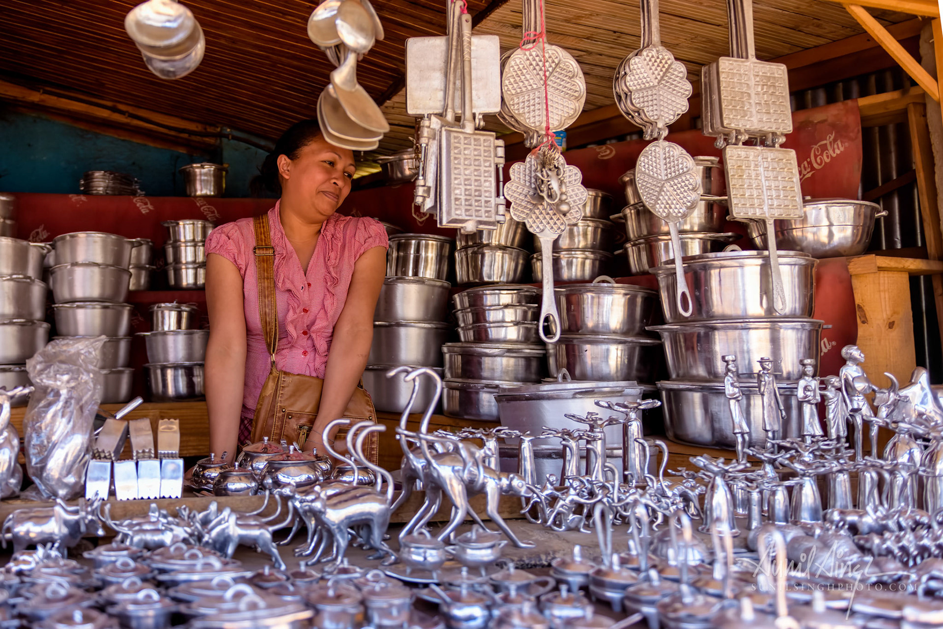 A woman selling aluminum crafts and pots, Ambatolampy