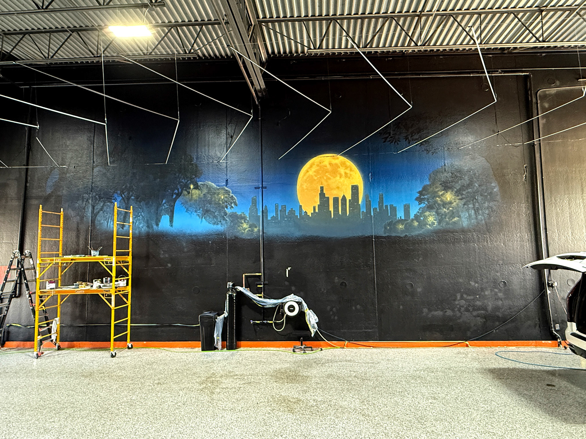 Dent Wolf Car Detailing Mural – Hand-Painted Chicago Skyline and Luxury Cars in Joliet, Illinois