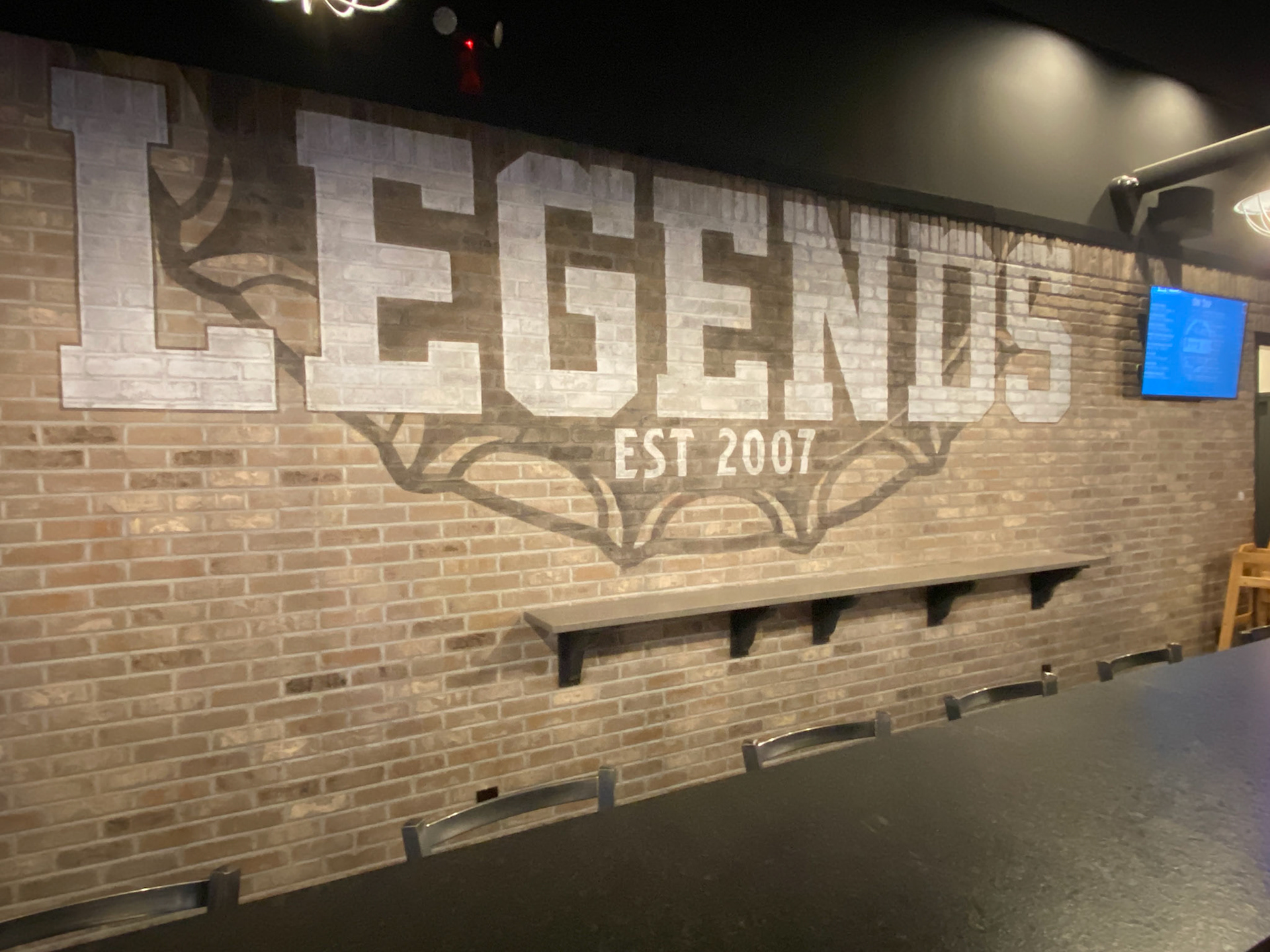 Hand painted logo on brick, aged and distressed