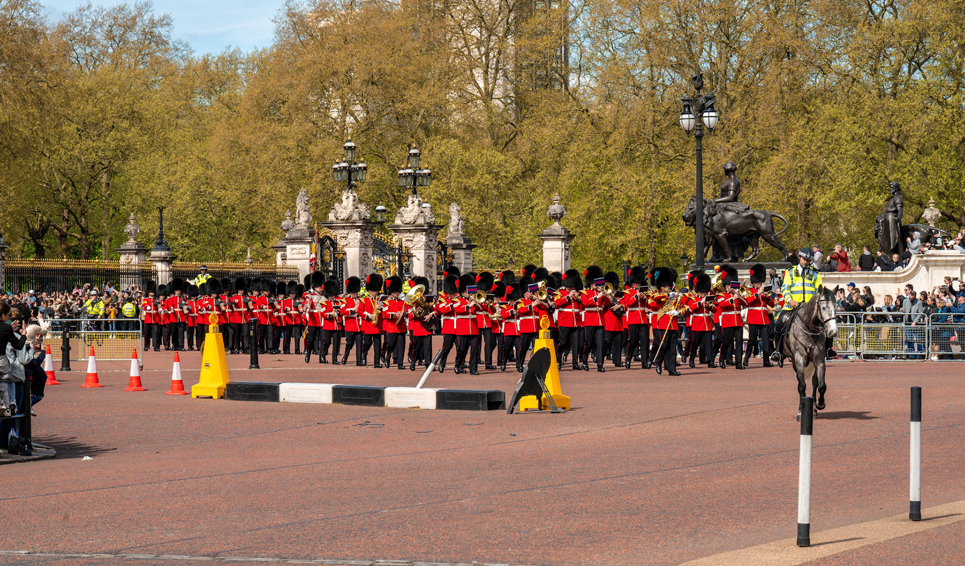 Accompanied by the band, the Old Guard departs Buckingham Palace, heading back to their barracks.