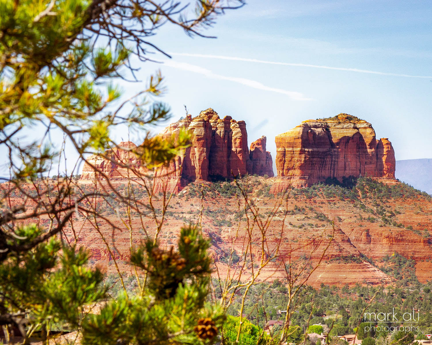 Buttes near Sedona, AZ, with out-of-focus branches in the foreground.